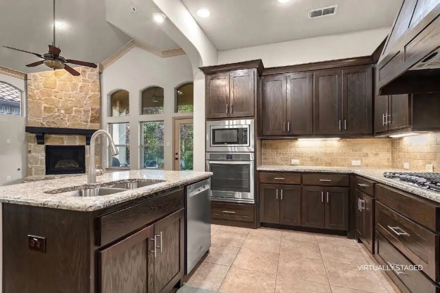 Kitchen overlooks the living space and features gorgeous wooden cabinets plus ample counterspace