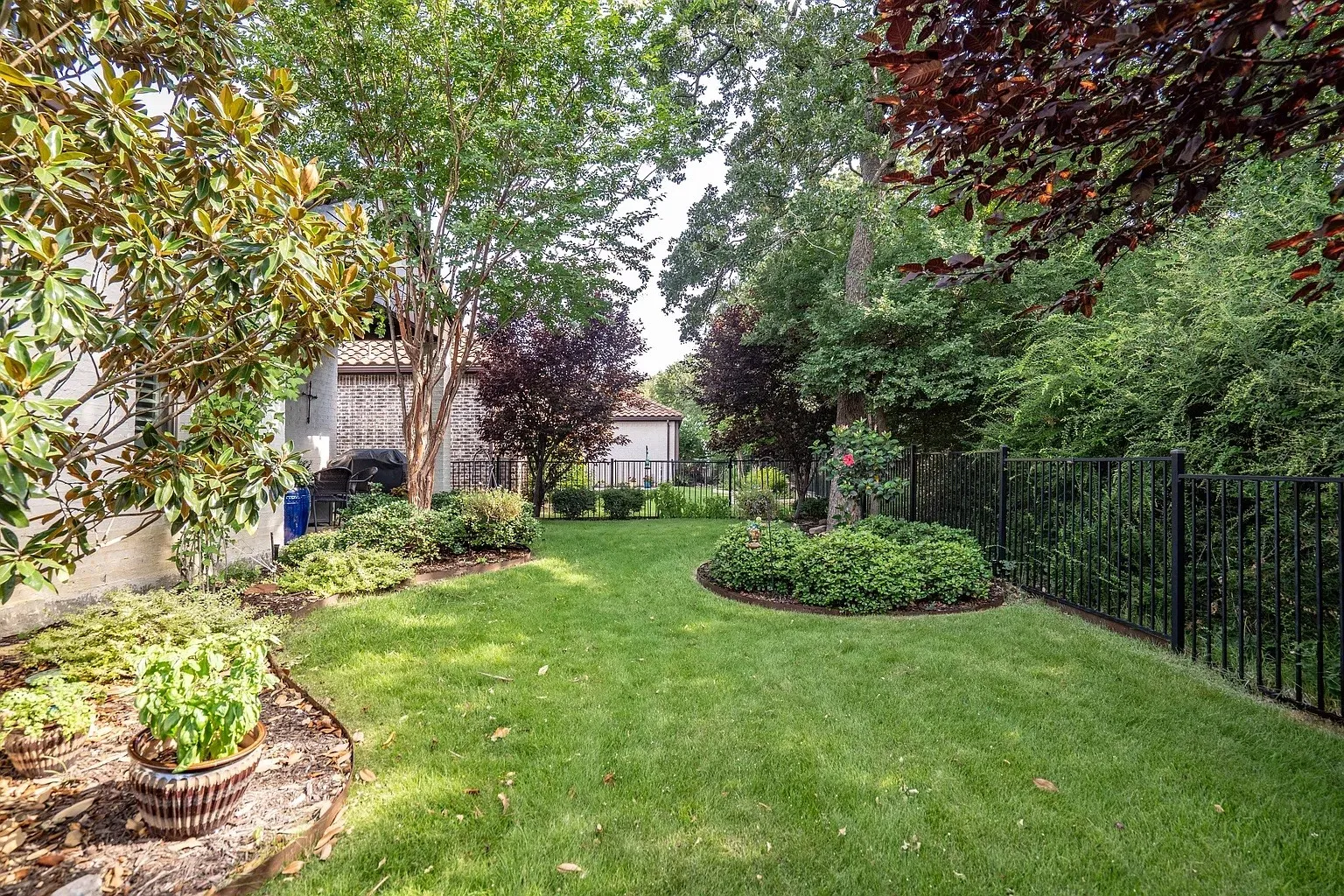 Incredible lush wrought-iron fenced yard backing to greenbelt. Maintained by HOA provided by landlord!