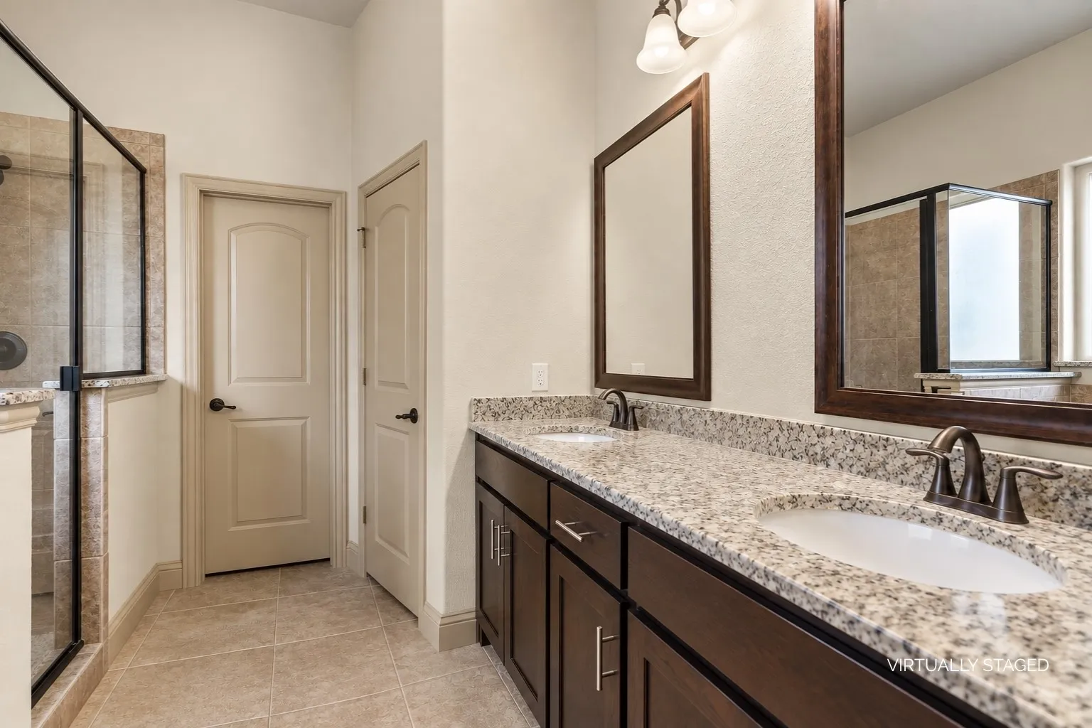 Separate dual sinks makes getting ready a breeze! Featuring generous counterspace and under sink cabinet storage. Private commode area and walk-in closet