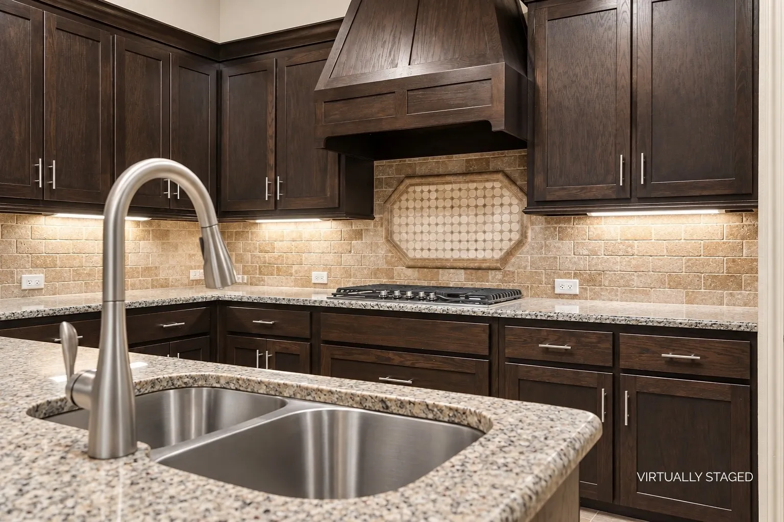 Dual undermount stainless steel sink. Abundant cabinet and counter space with gas cooktop and vented hood