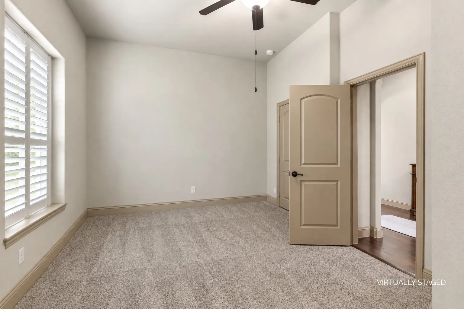 Secondary Downstairs Bedroom with ceiling fan and closet