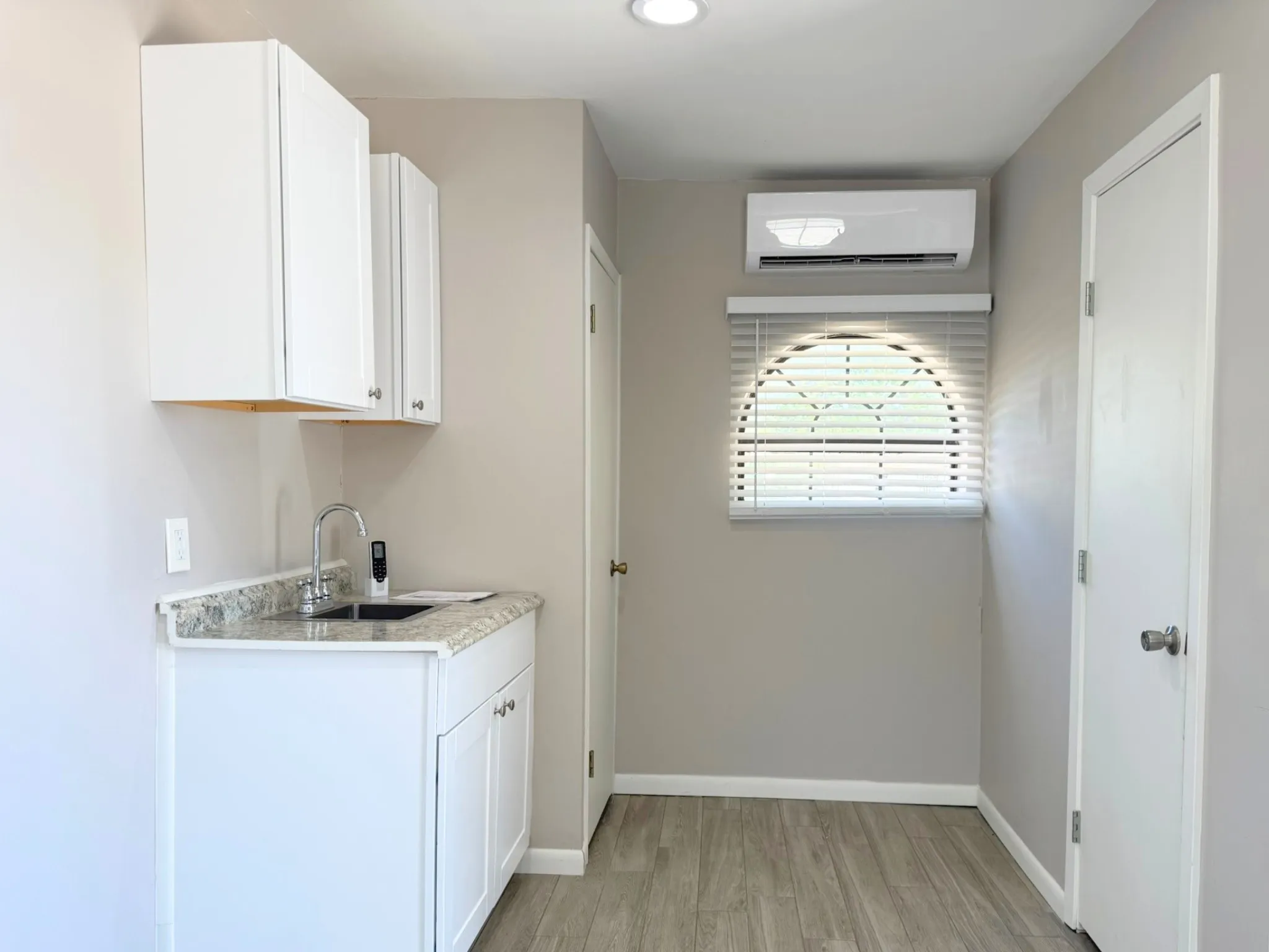 Small kitchenette area with storage and sink