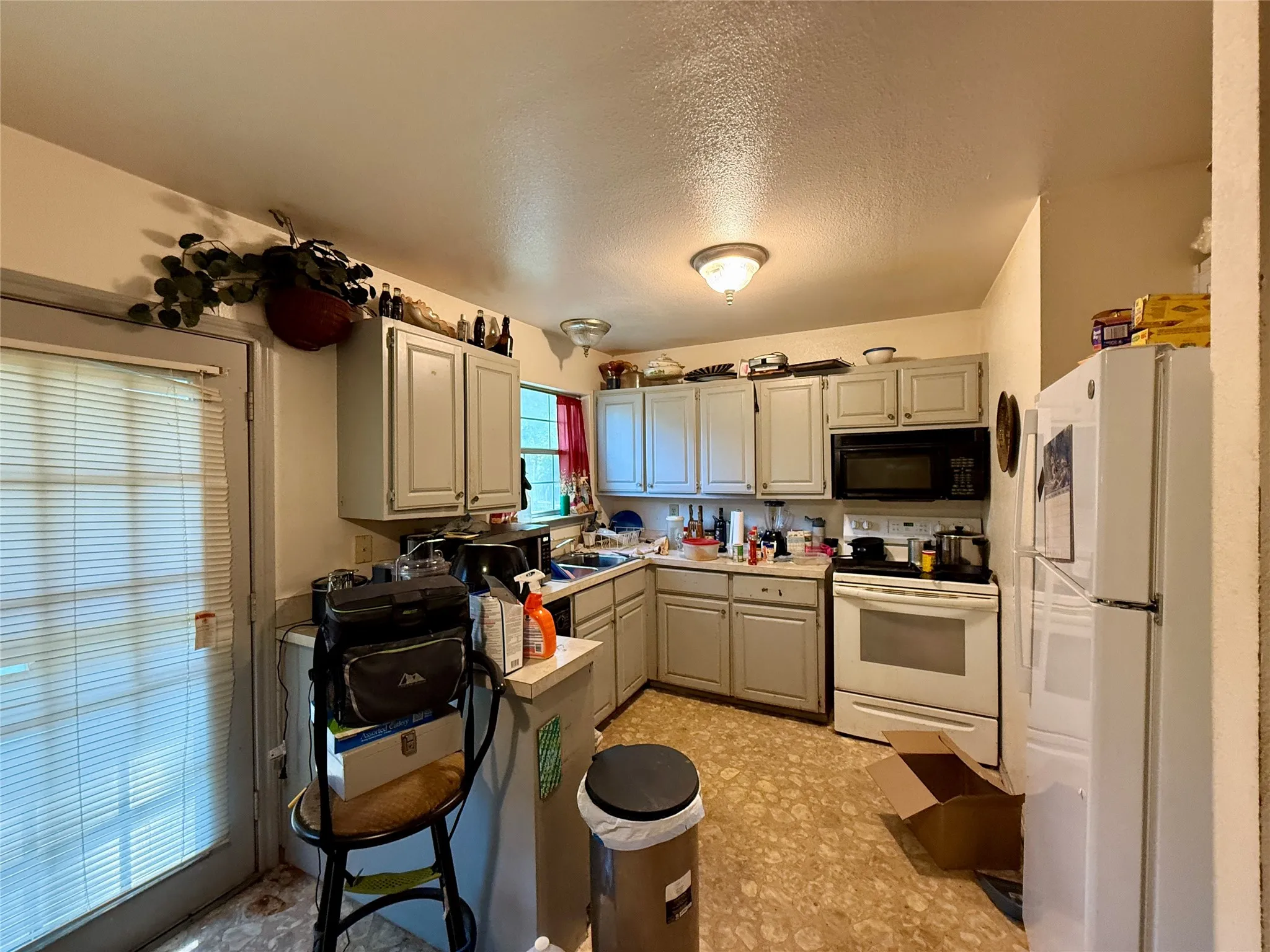 Kitchen featuring ample cabinetry, built-in microwave, and a glass-paneled exterior door