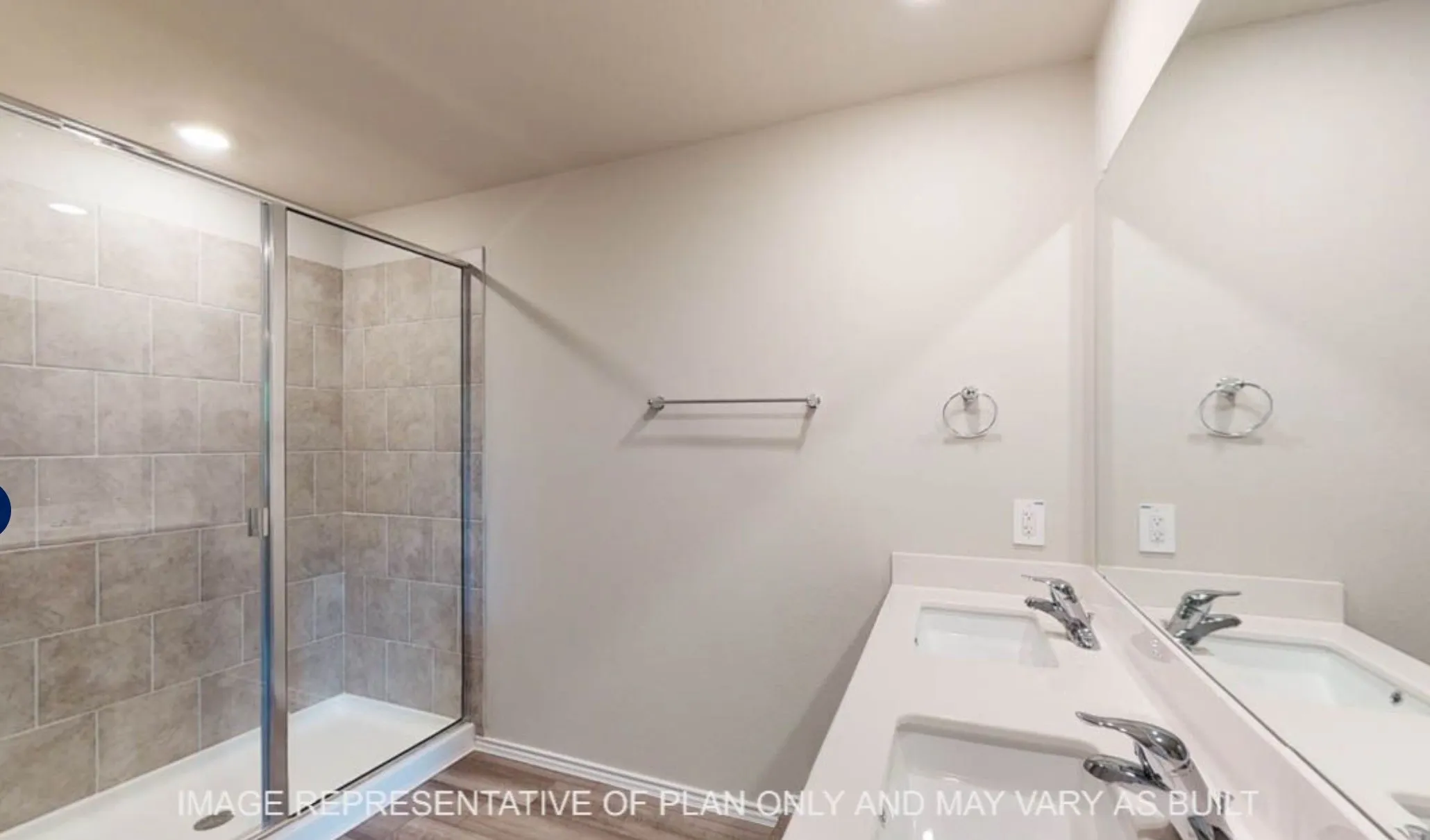 Glass-enclosed shower with subway tile surround, dual vanity with undermount sinks, and chrome fixtures