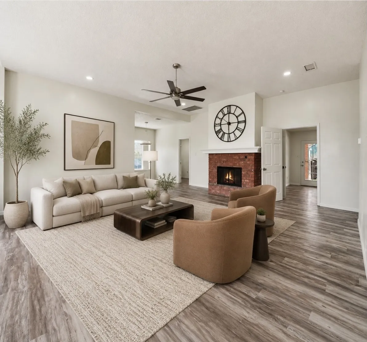 AI Staging. Spacious living area featuring wood-finish flooring, a ceiling fan, recessed lighting, a brick-surround fireplace, and a white mantel