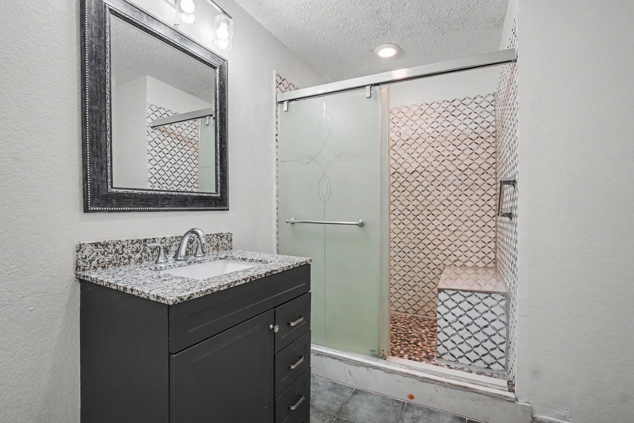 Vanity with granite countertop and undermount sink