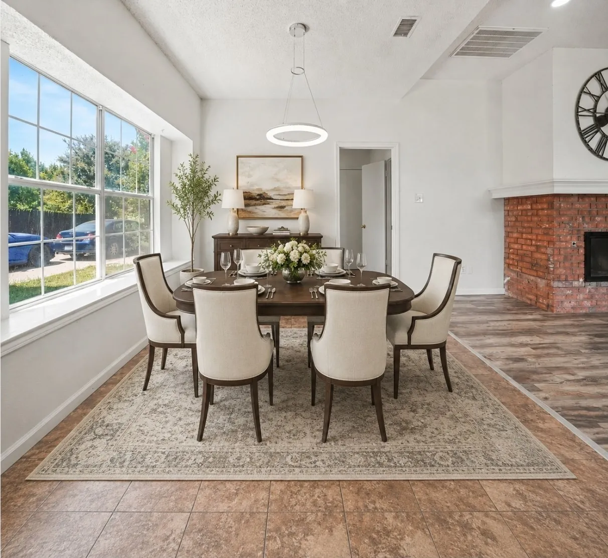 AI Staging. Expansive window with grid detailing, modern circular pendant lighting, and a brick fireplace