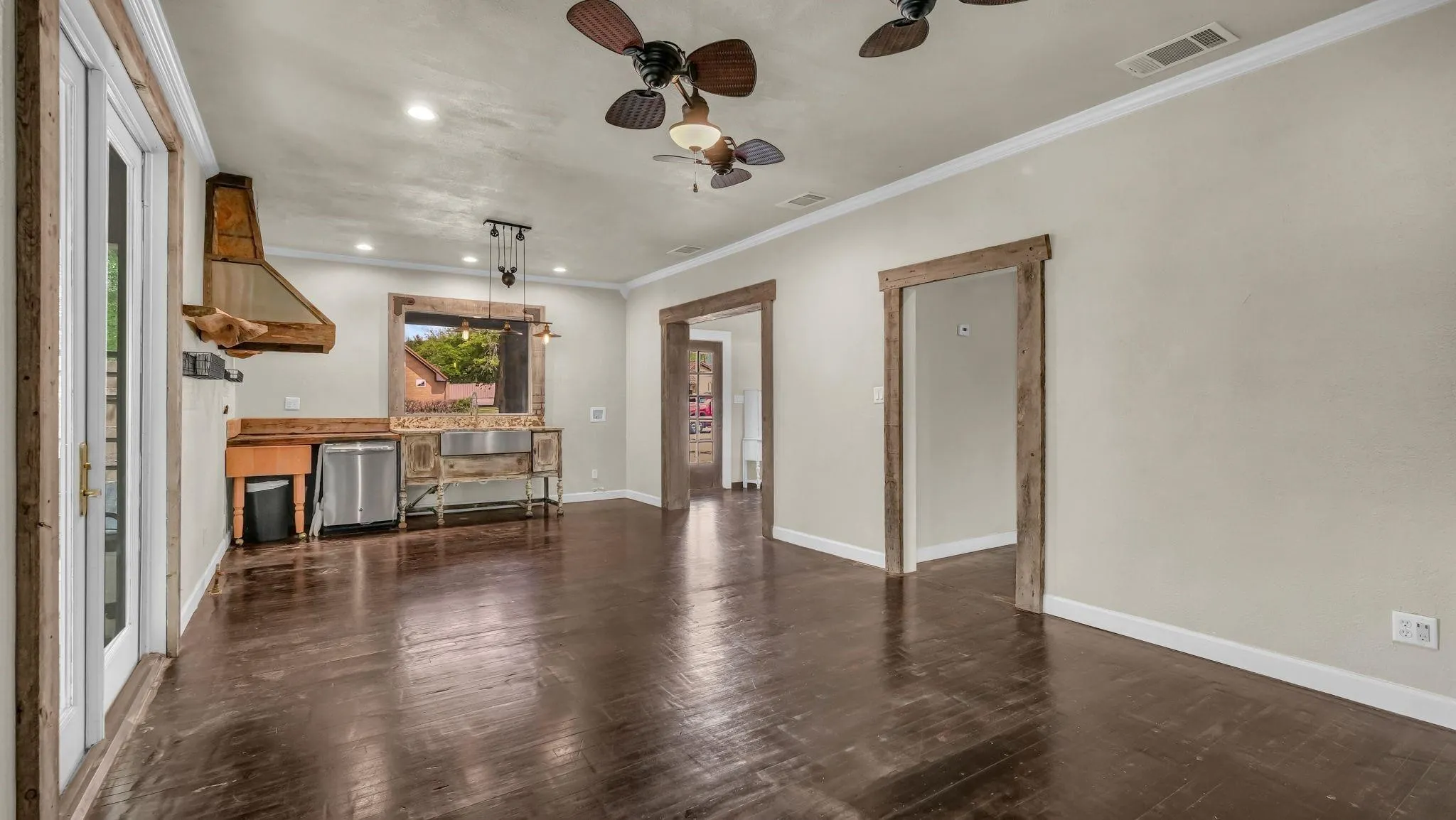 Spacious area featuring dark wood-finish flooring, recessed lighting, and ceiling fans