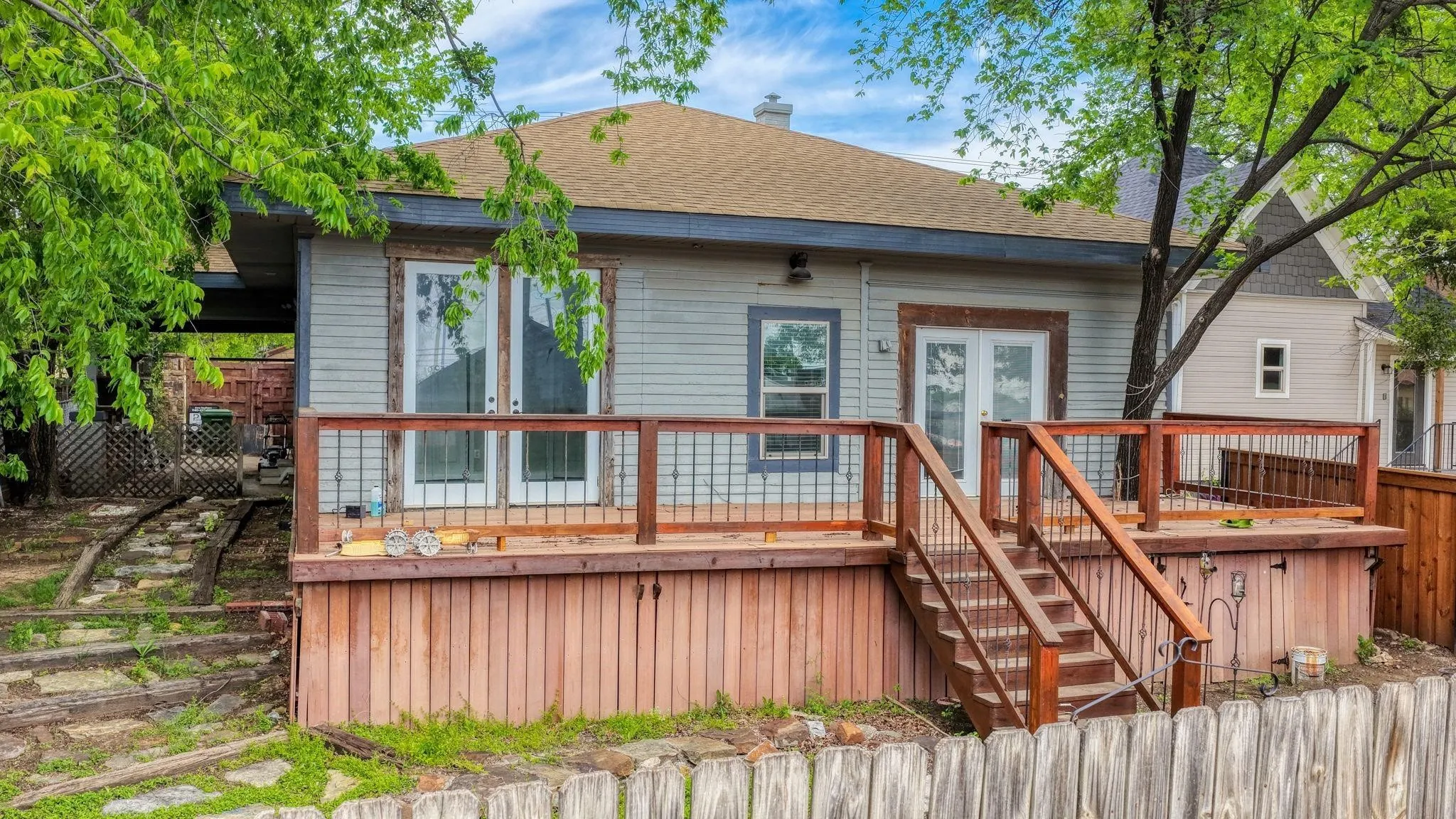 Wood-finish deck with railing and dual staircases