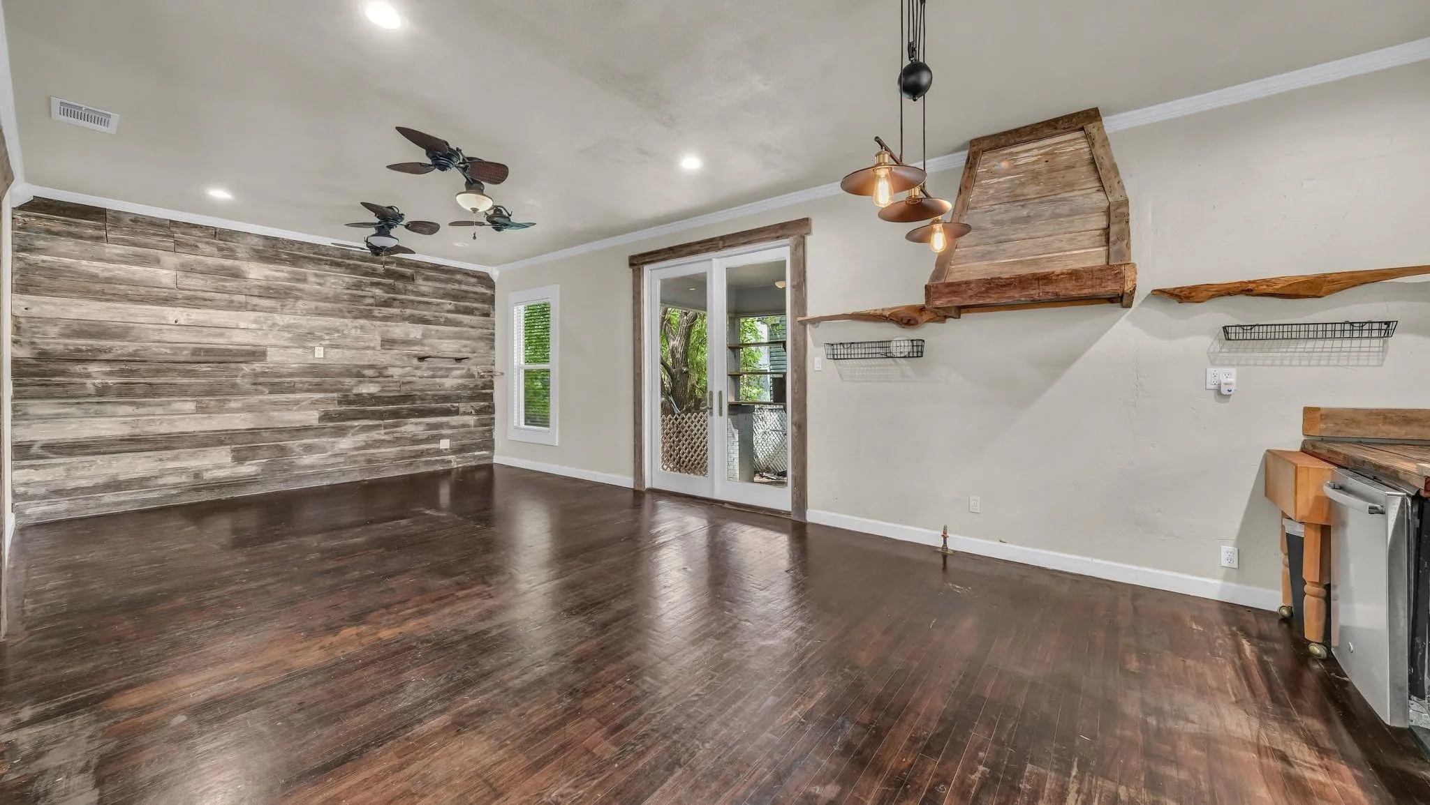 Wood-finish flooring throughout, complemented by a distressed wood-paneled accent wall