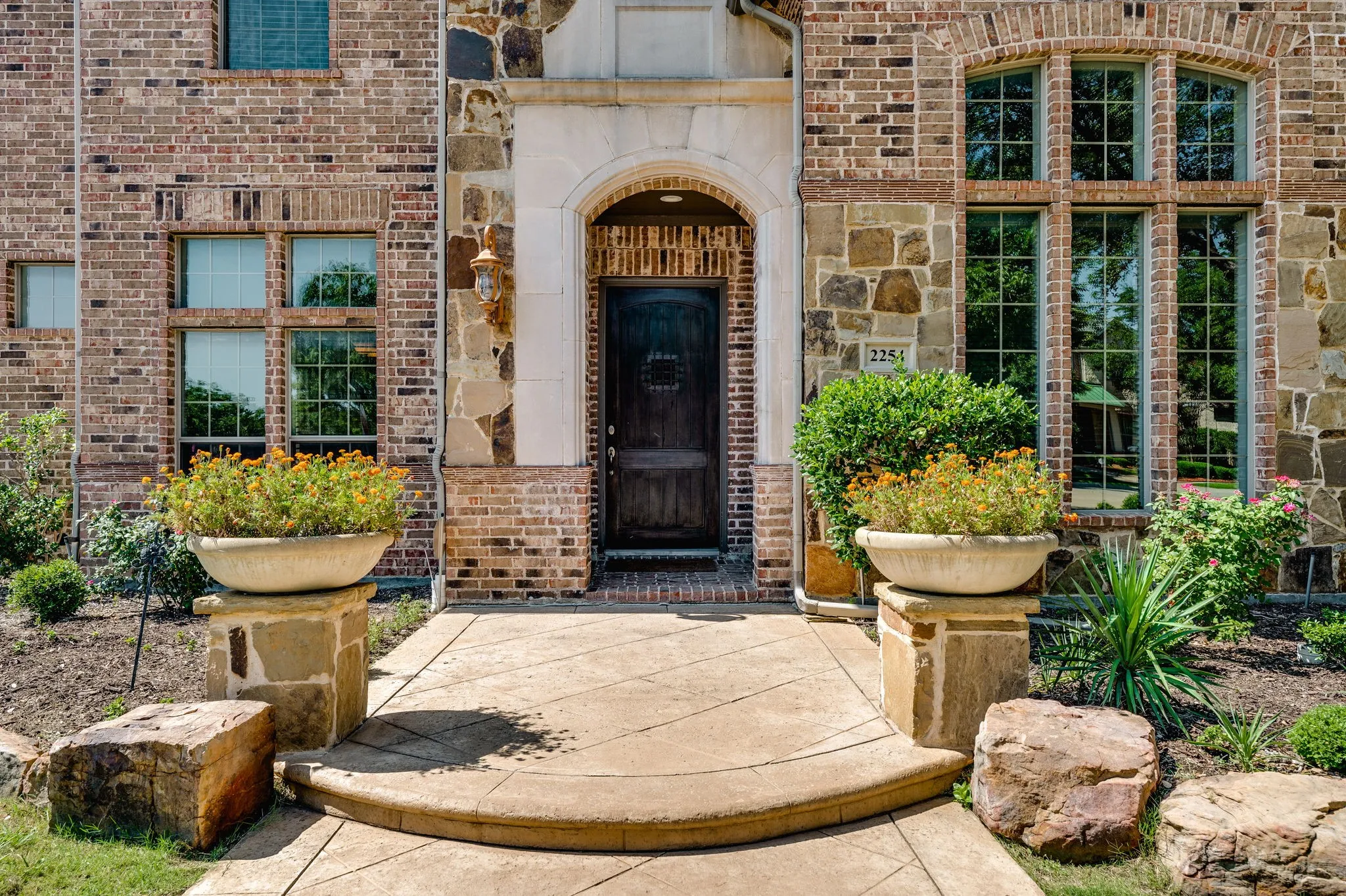 Brick and stone exterior with arched entryway