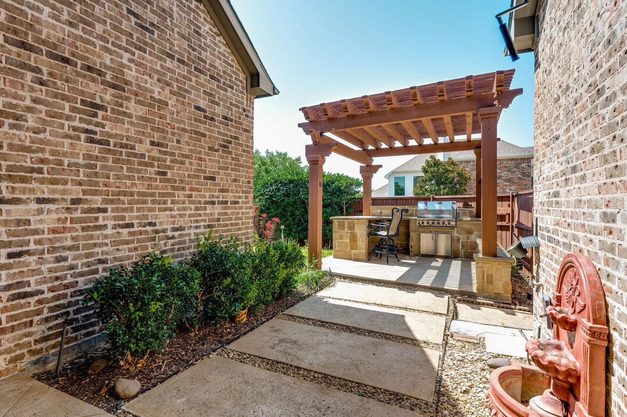 Outdoor kitchen with a built-in grill and stone counter
