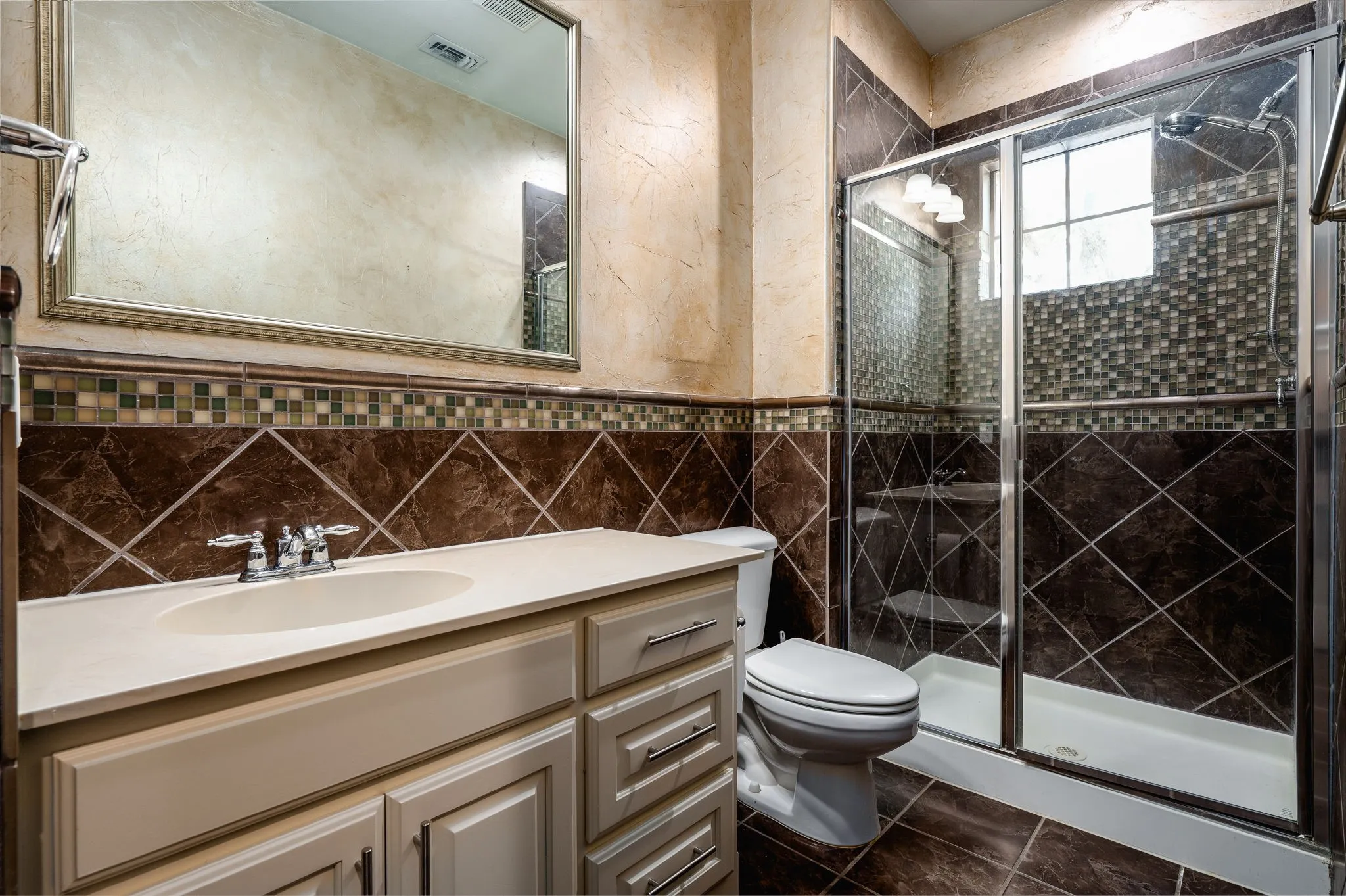 Vanity with an integrated sink, framed mirror, and chrome fixtures