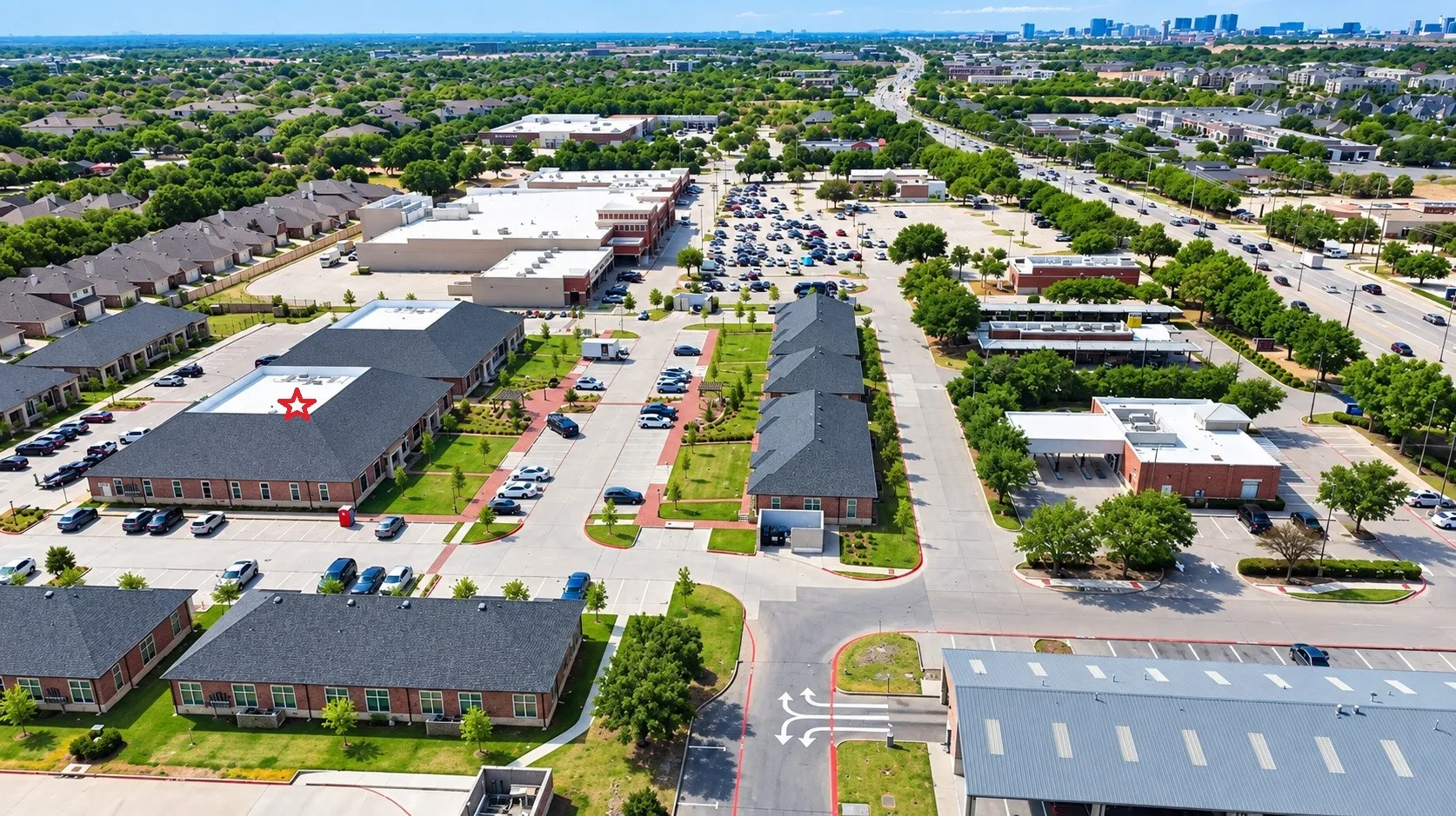 Commercial property with multiple buildings, ample surface parking, and brick exteriors