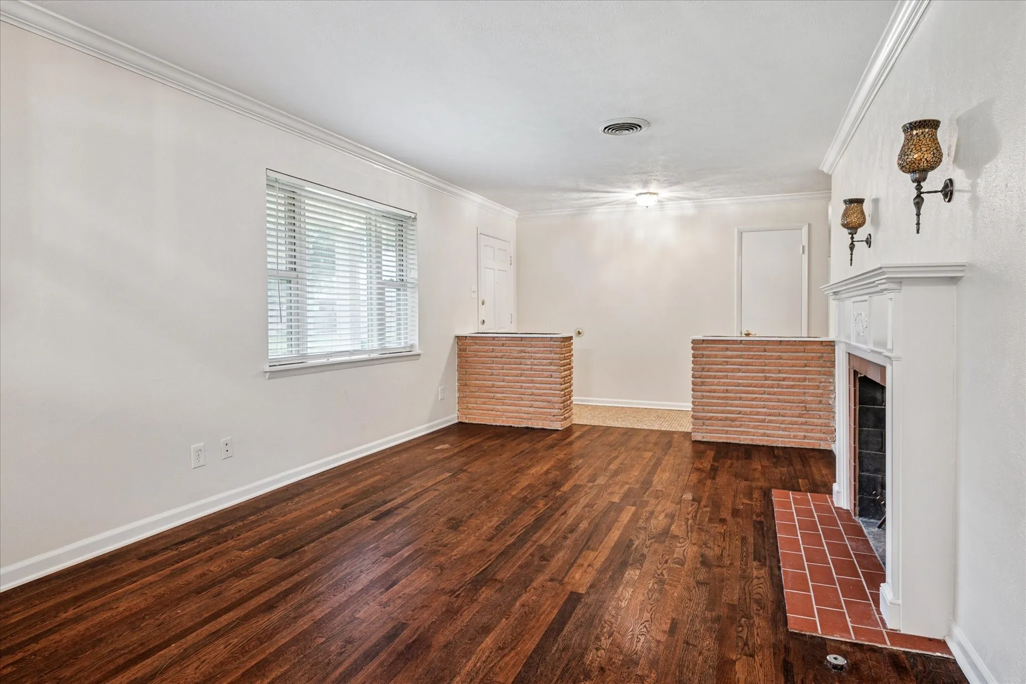 Open formals with original oak hardwoods, brick planters, and tiled entry.