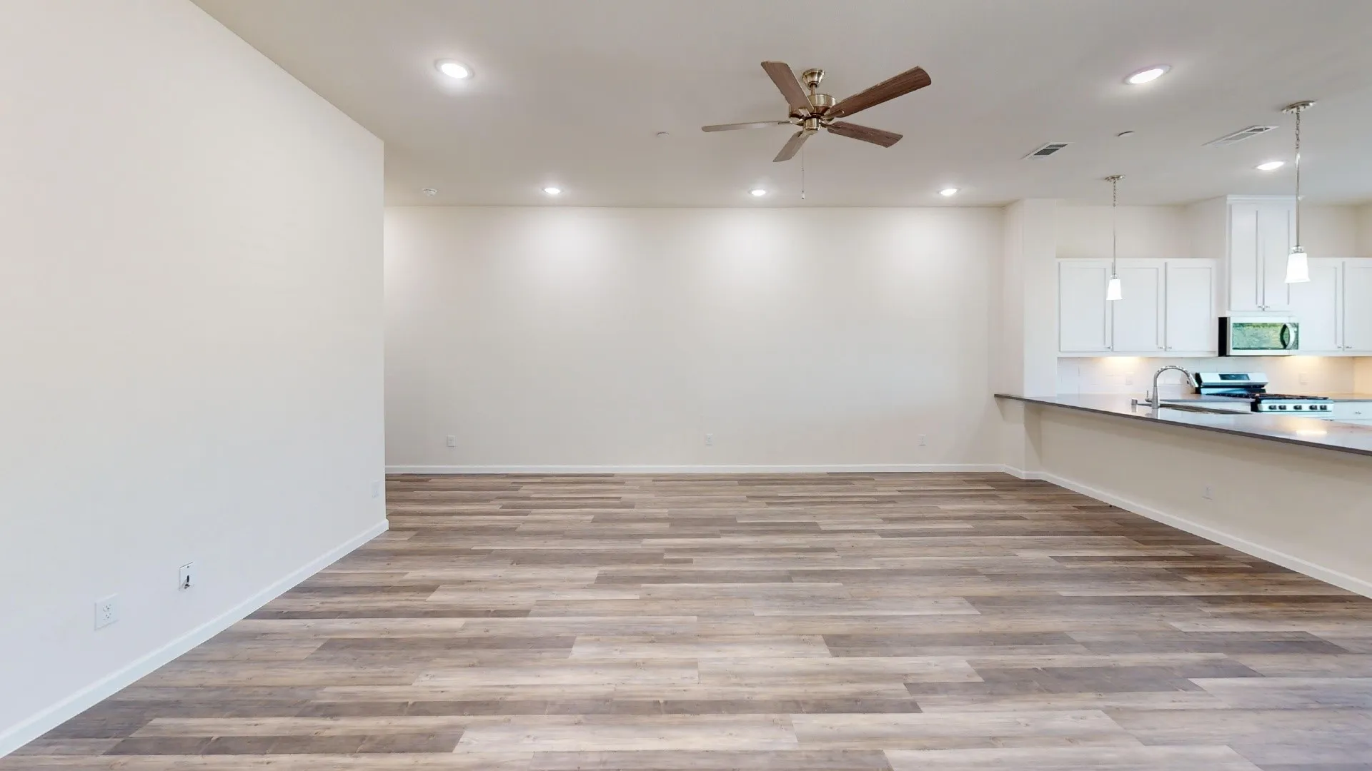 Wood-finish flooring, recessed lighting, and a ceiling fan