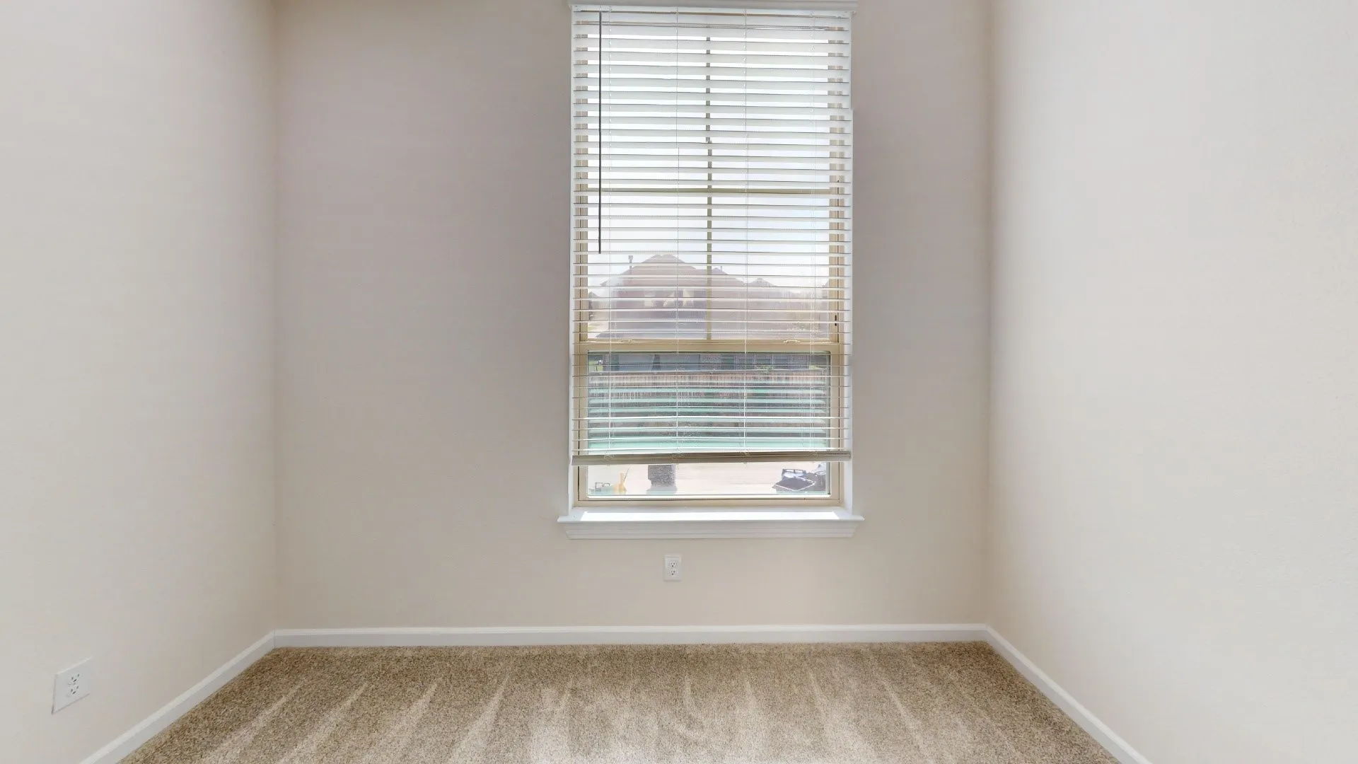 Single window with horizontal blinds, neutral wall tones, and carpet flooring