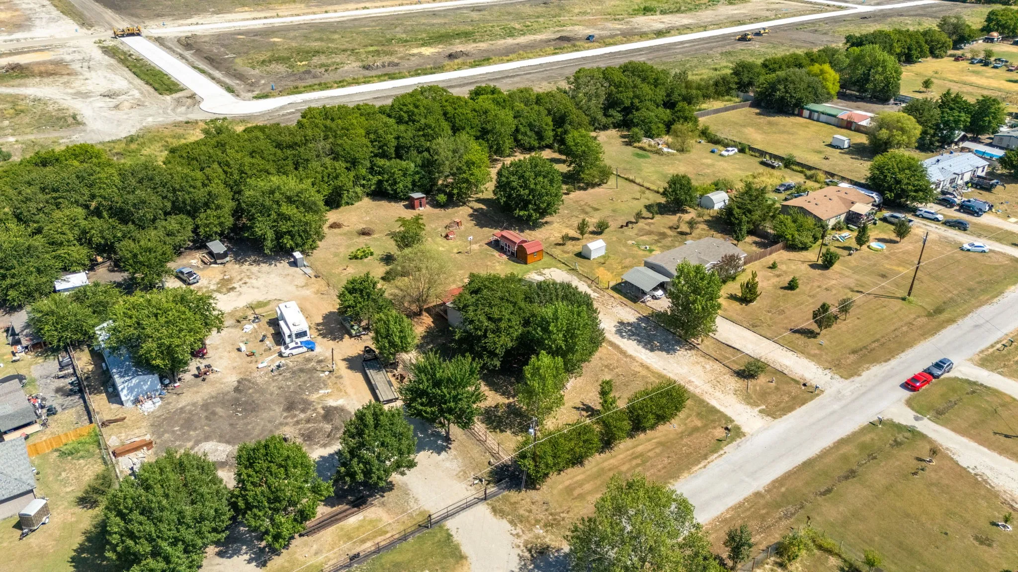 Aerial perspective showcasing multiple land parcels and residential structures