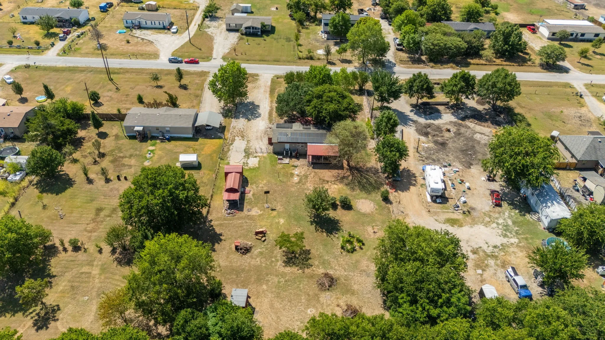 Expansive lot featuring mature trees and a gravel driveway