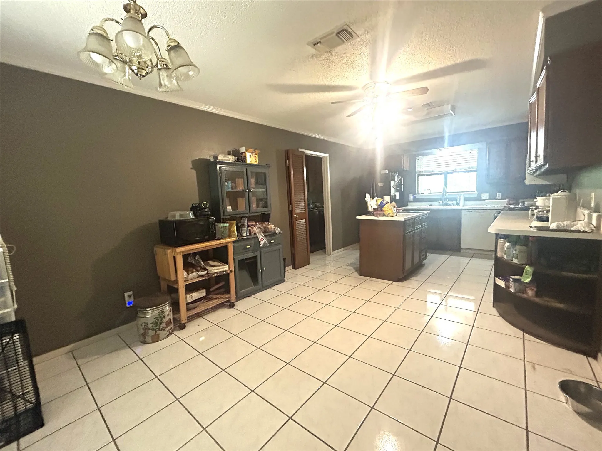 Dining area looking toward the kitchen and door to the laundry room, pantry and 2 car garage