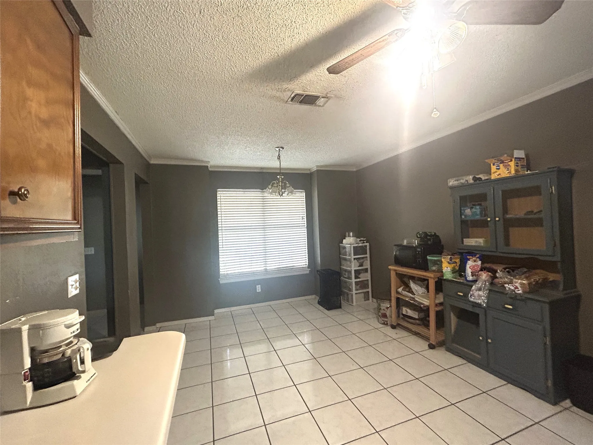 Dining area with large window and tile floors