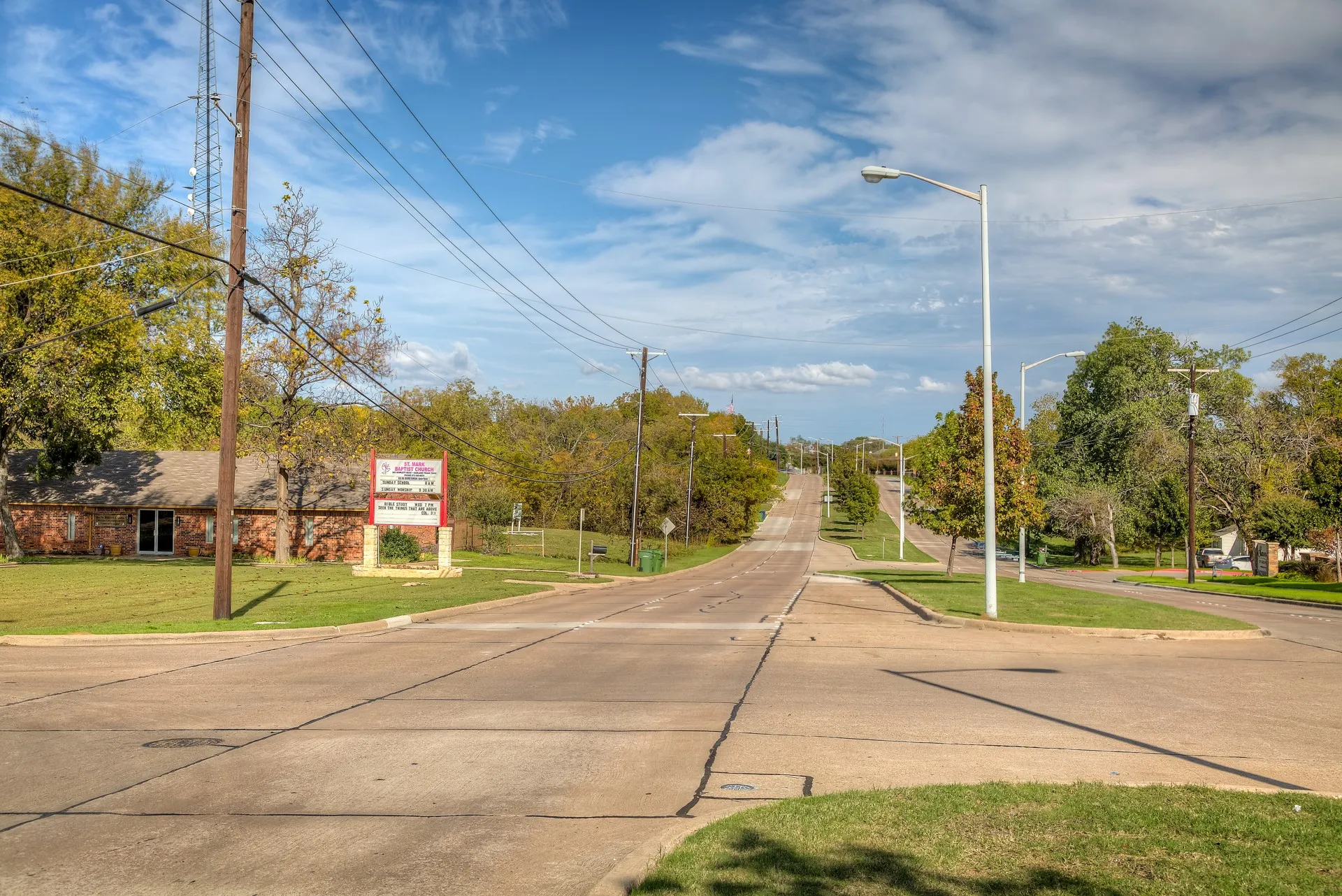 View of concrete street with curbs and street lights