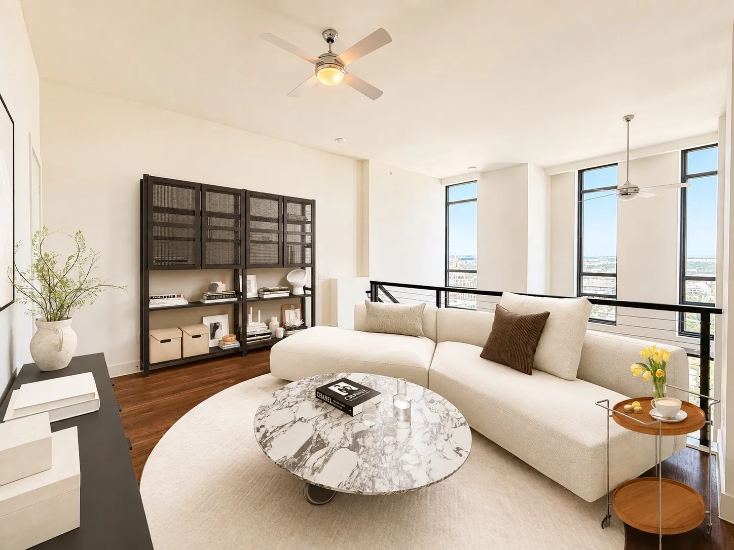 Hardwood flooring throughout, complemented by a contemporary railing system