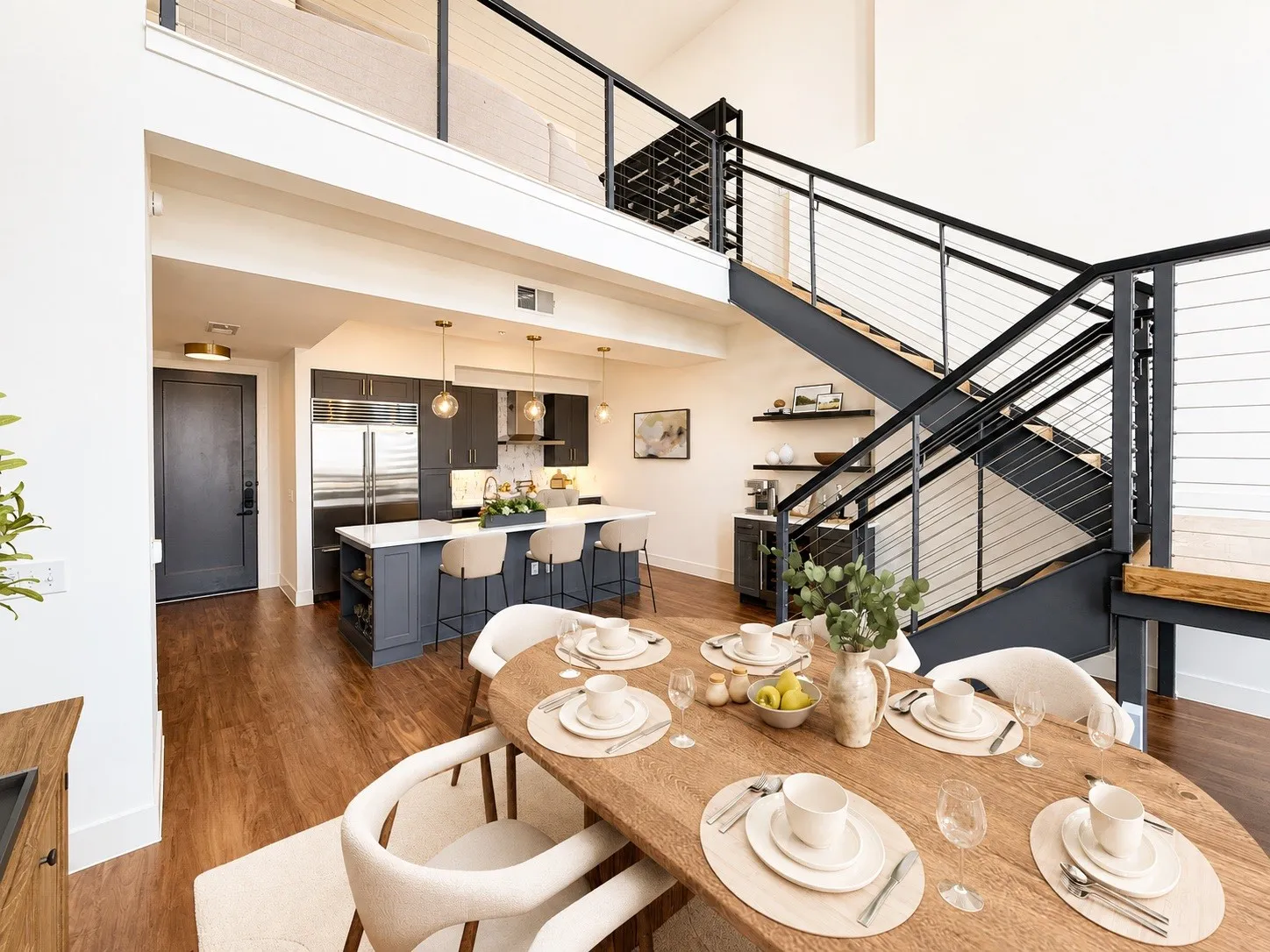 Open-concept living space with high ceilings and wood-finish flooring