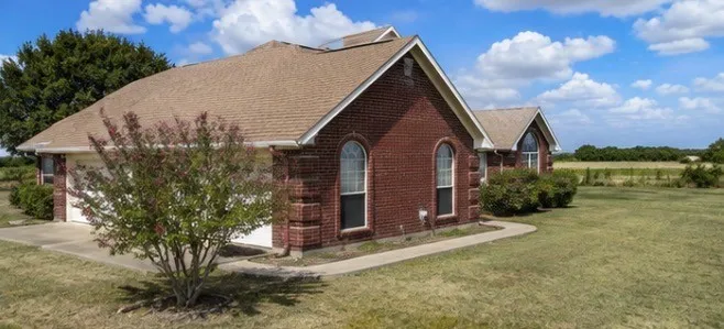 Brick exterior with light brown shingle roof