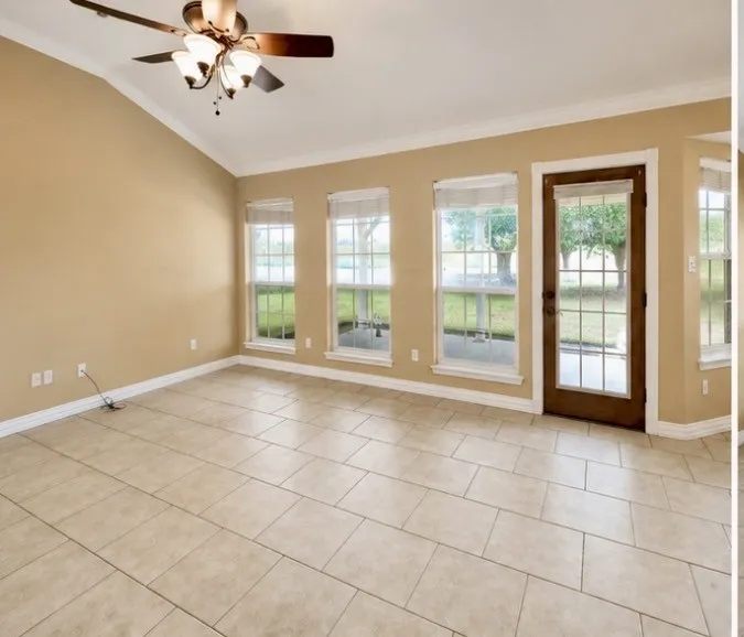 Living area with picture windows abd wooden back patio door