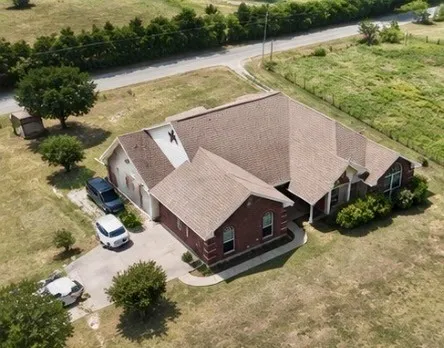 Brick veneer exterior, multiple gables, arched window, attached garage, paved driveway