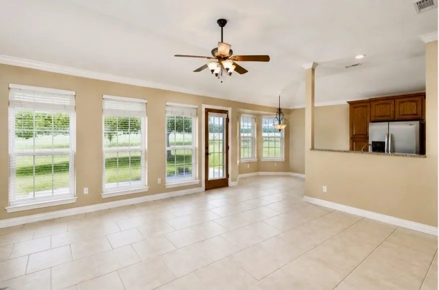 Spacious living area with picture windows opening up to the green pasture