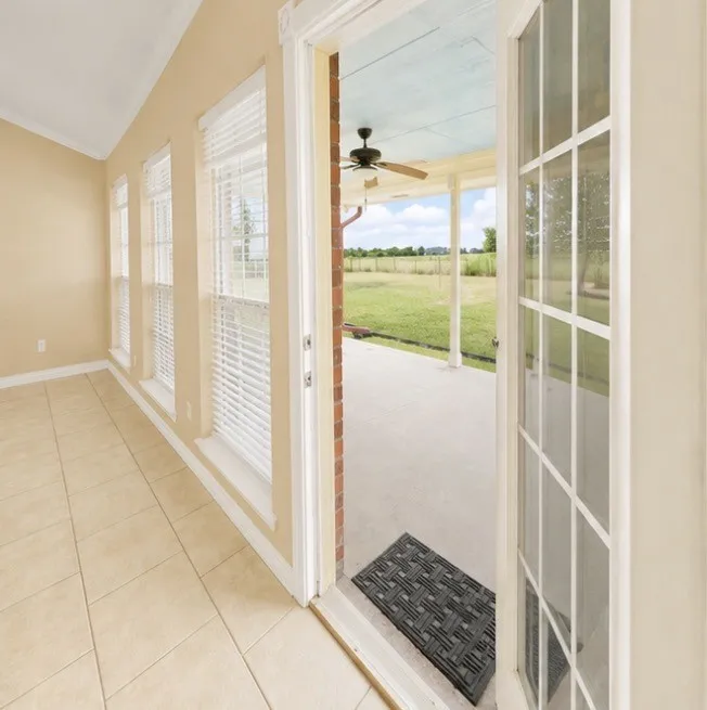Tiled flooring and multiple windows with blinds