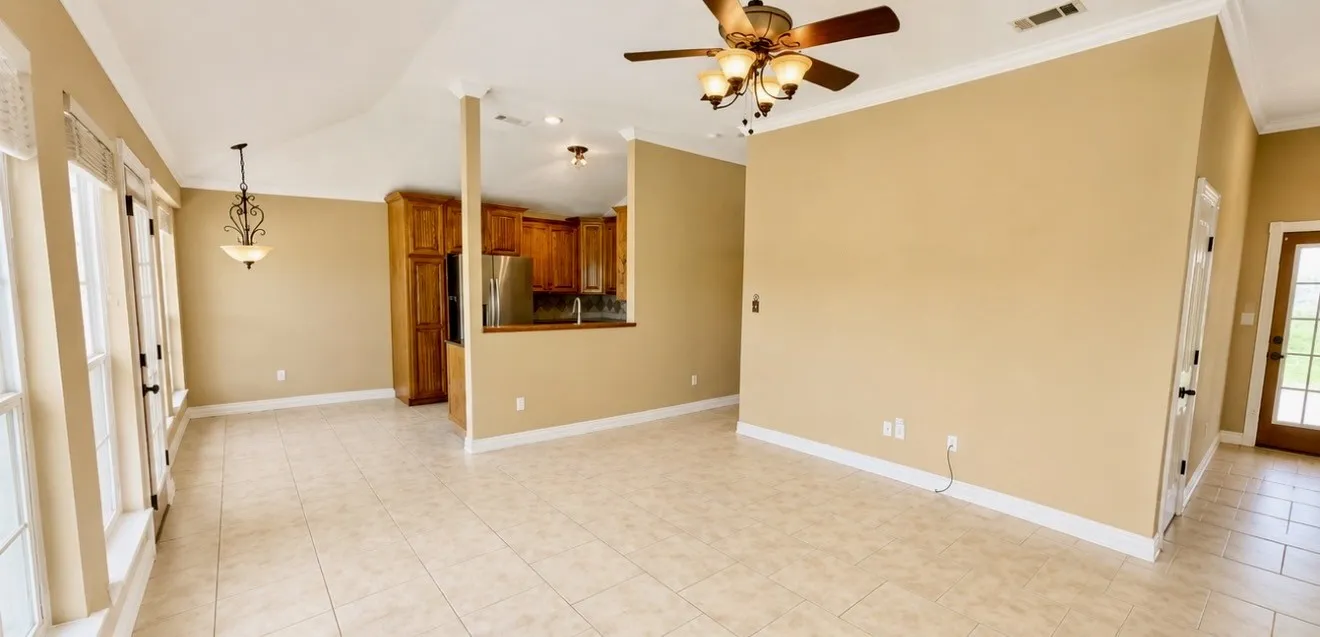 Tiled living room with kitchen and entry door