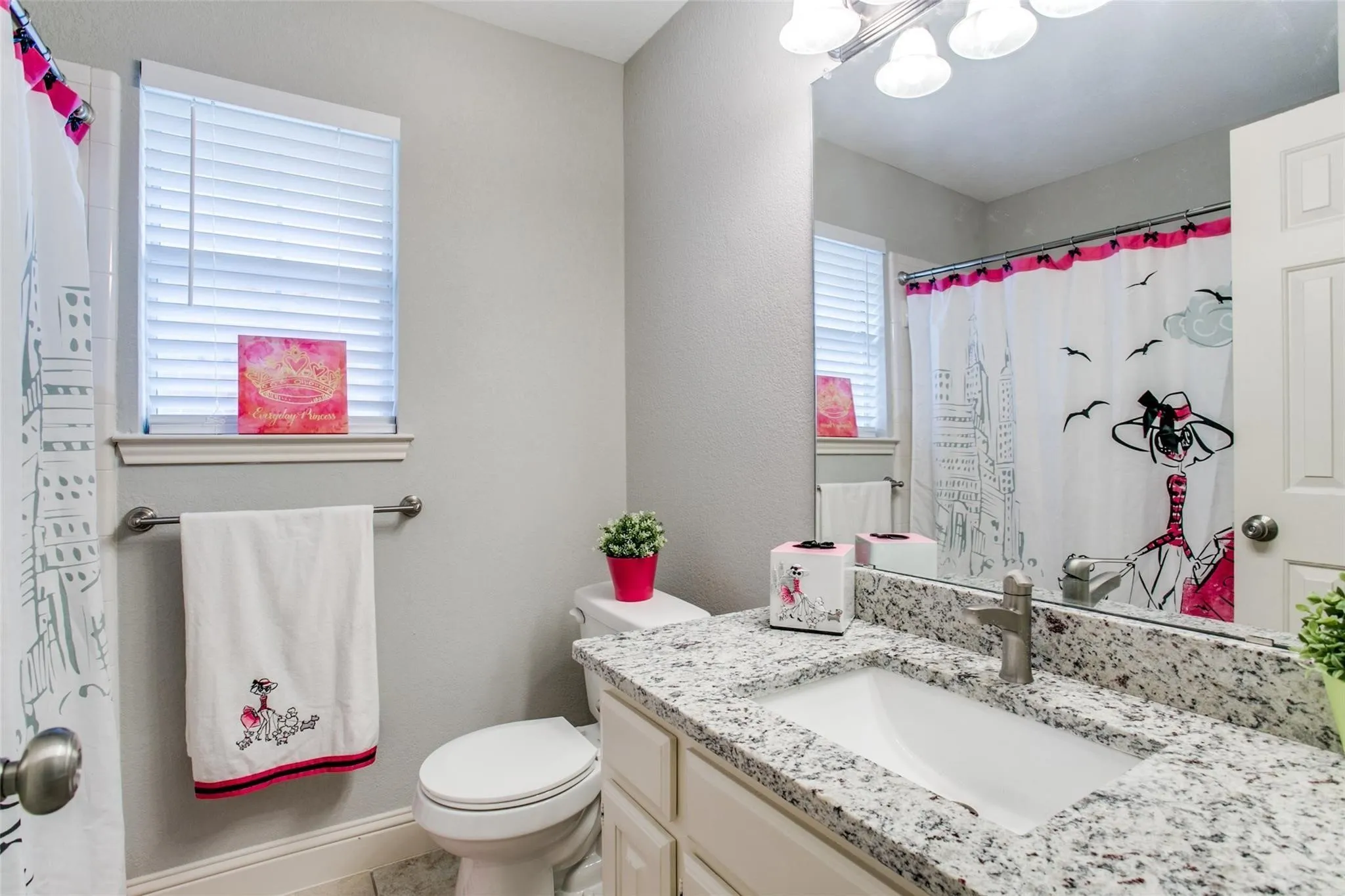 White vanity with a rectangular undermount sink, a chrome faucet, and a light-toned speckled countertop