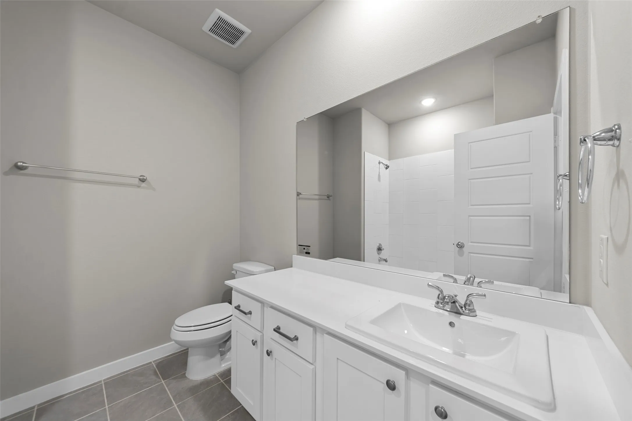 White vanity with integrated sink and chrome fixtures