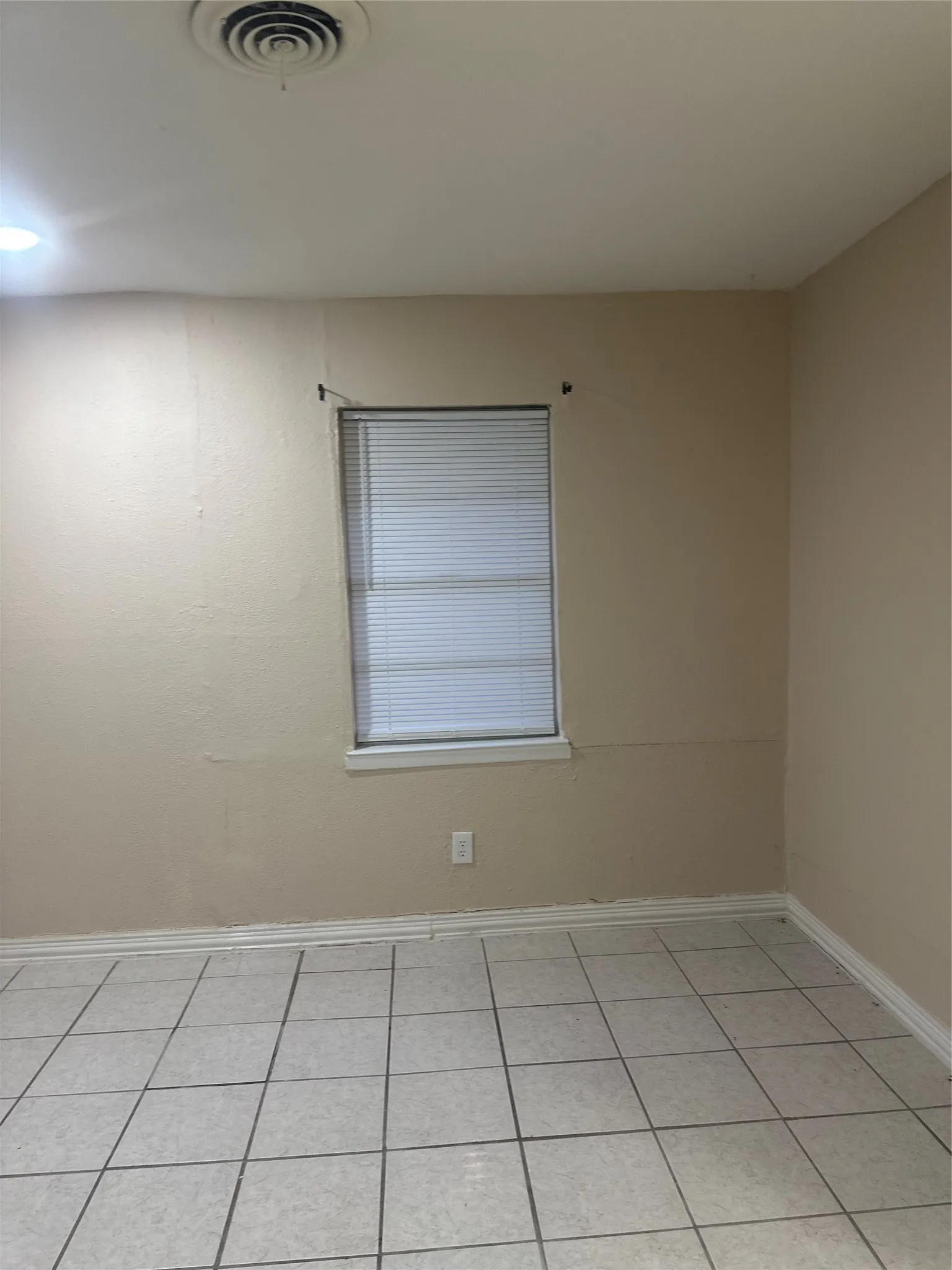 Tile flooring, white window trim, white baseboards, recessed lighting, ceiling-mounted air vent