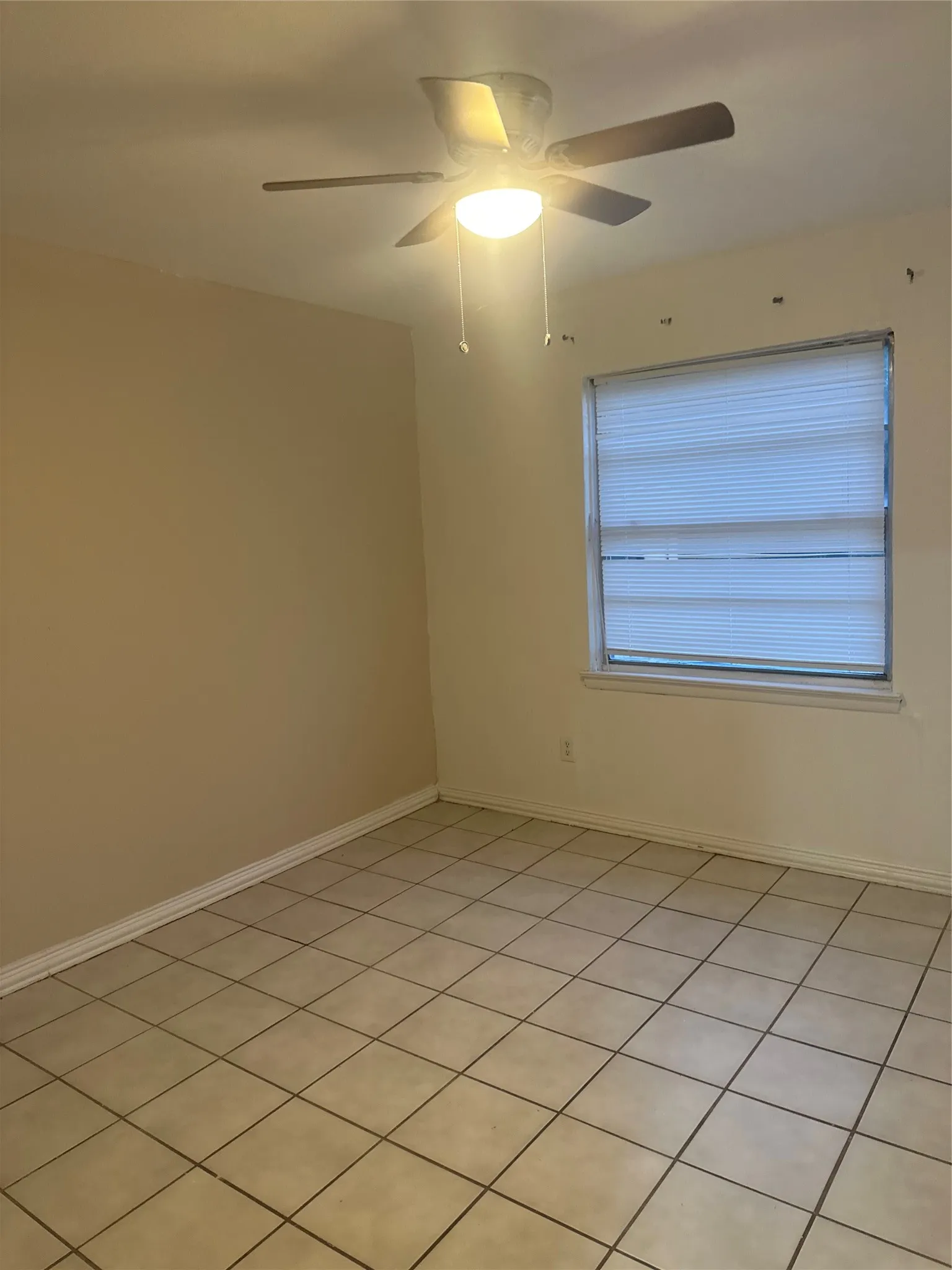 Tiled flooring and a ceiling fan with light fixture
