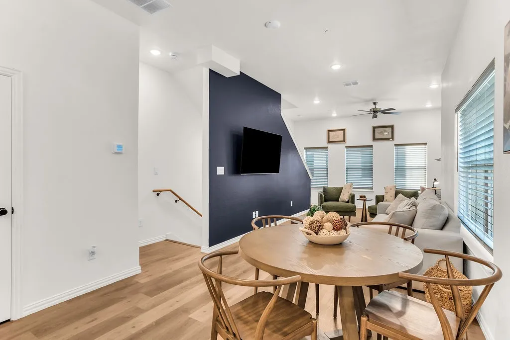 Open-concept living space with wood-finish flooring, recessed lighting, and a ceiling fan