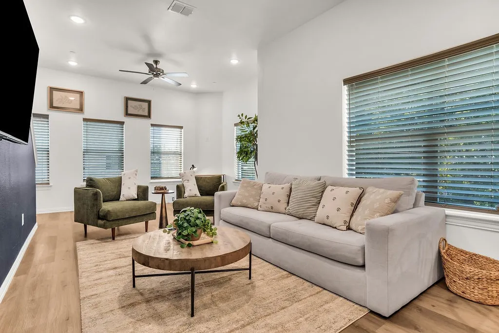 Recessed lighting, ceiling fan, multiple windows with blinds, wood-finish flooring, and white painted walls