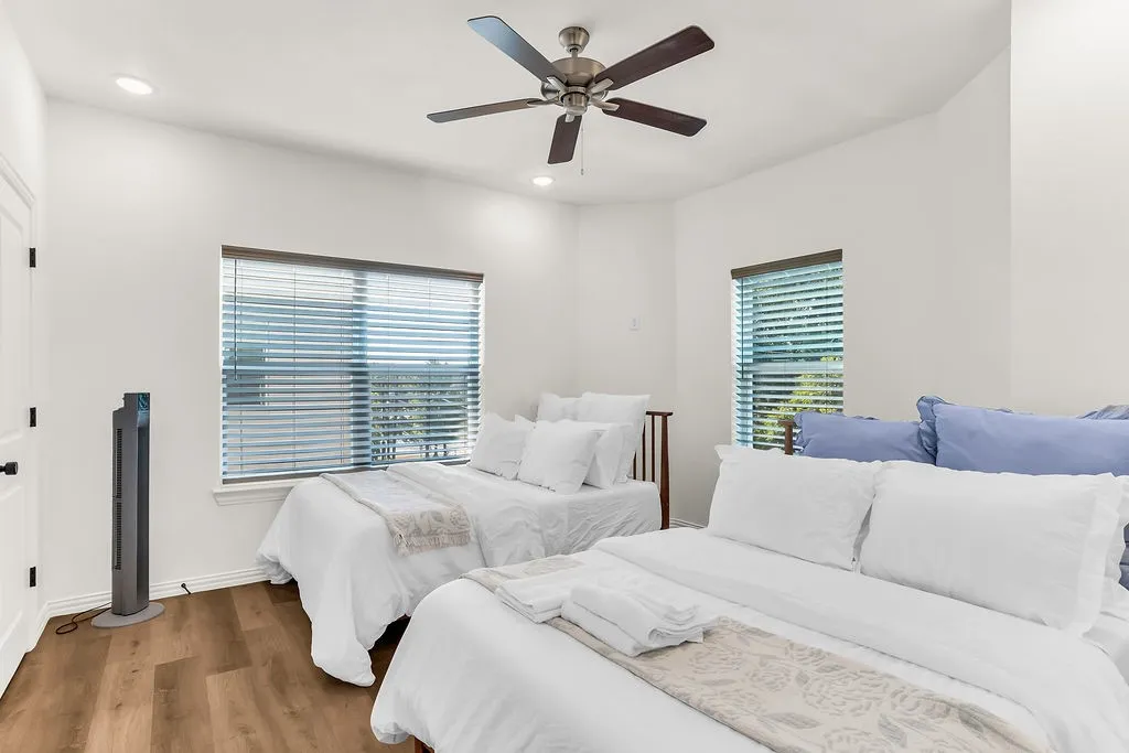 Recessed lighting, wood-finish flooring, ceiling fan, and window with blinds