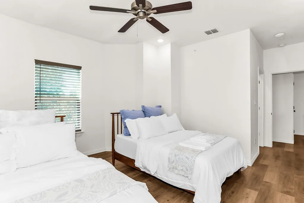 Wood-finish flooring, recessed lighting, ceiling fan, and window with blinds
