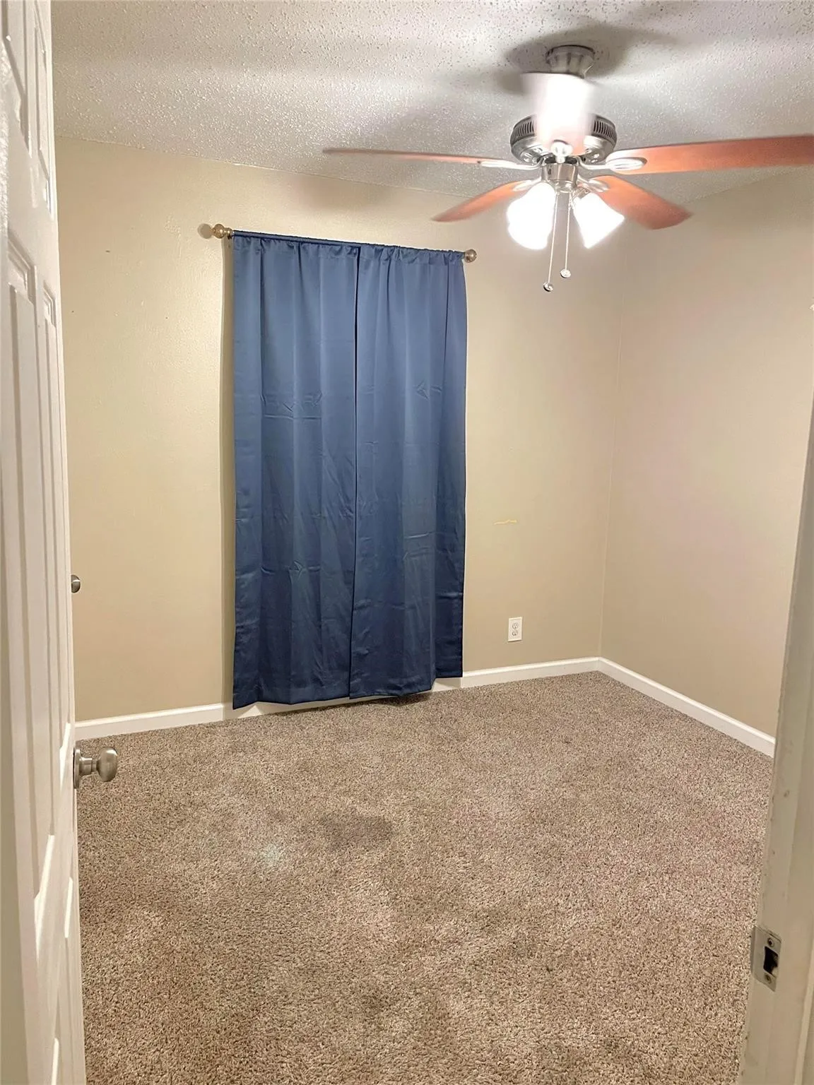 Bedroom with carpet and a textured ceiling