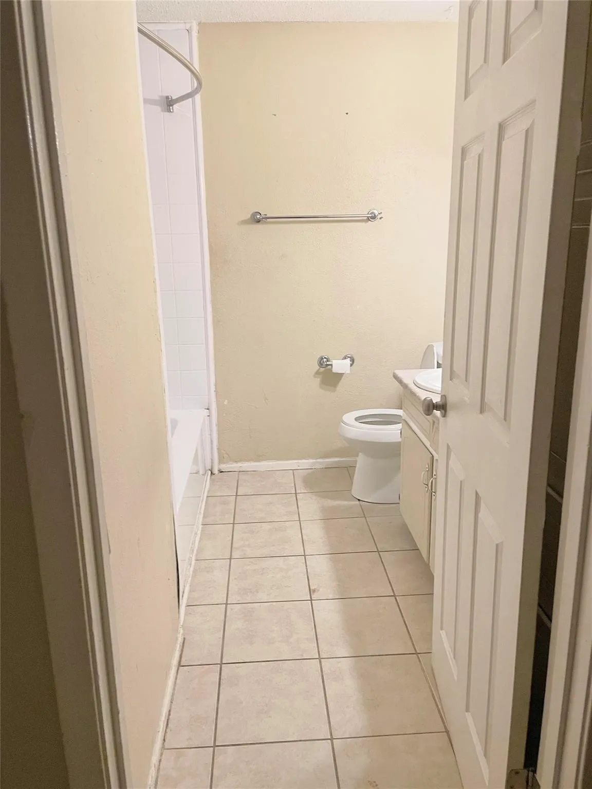 Full Hall bathroom featuring shower / bathing tub combination, tile patterned flooring, vanity, and toilet