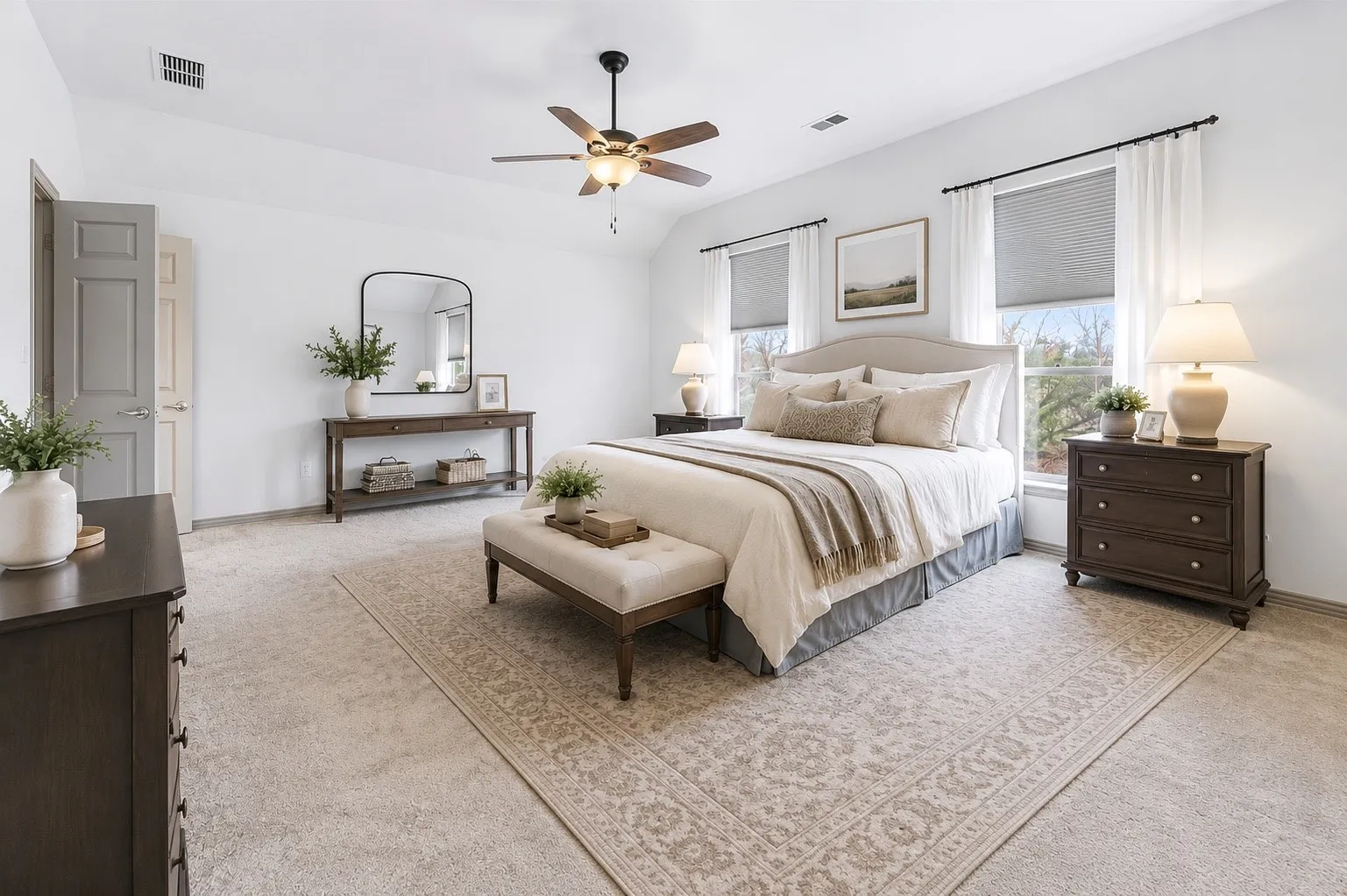 Vaulted ceiling with a ceiling fan, two windows with blinds and curtains, and carpet flooring