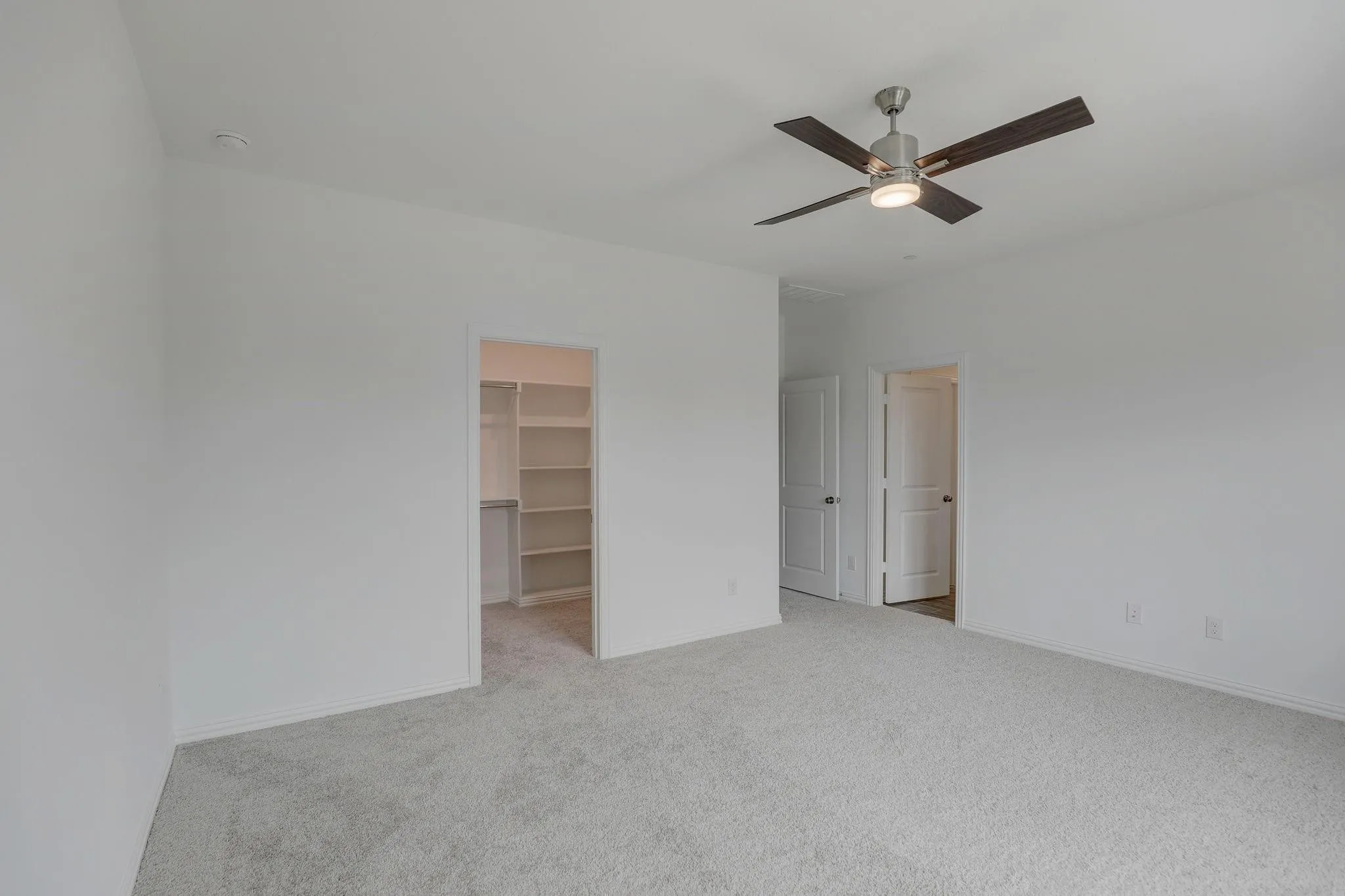 Recessed lighting, ceiling fan with light fixture, carpeted flooring, built-in closet shelving, and white interior doors