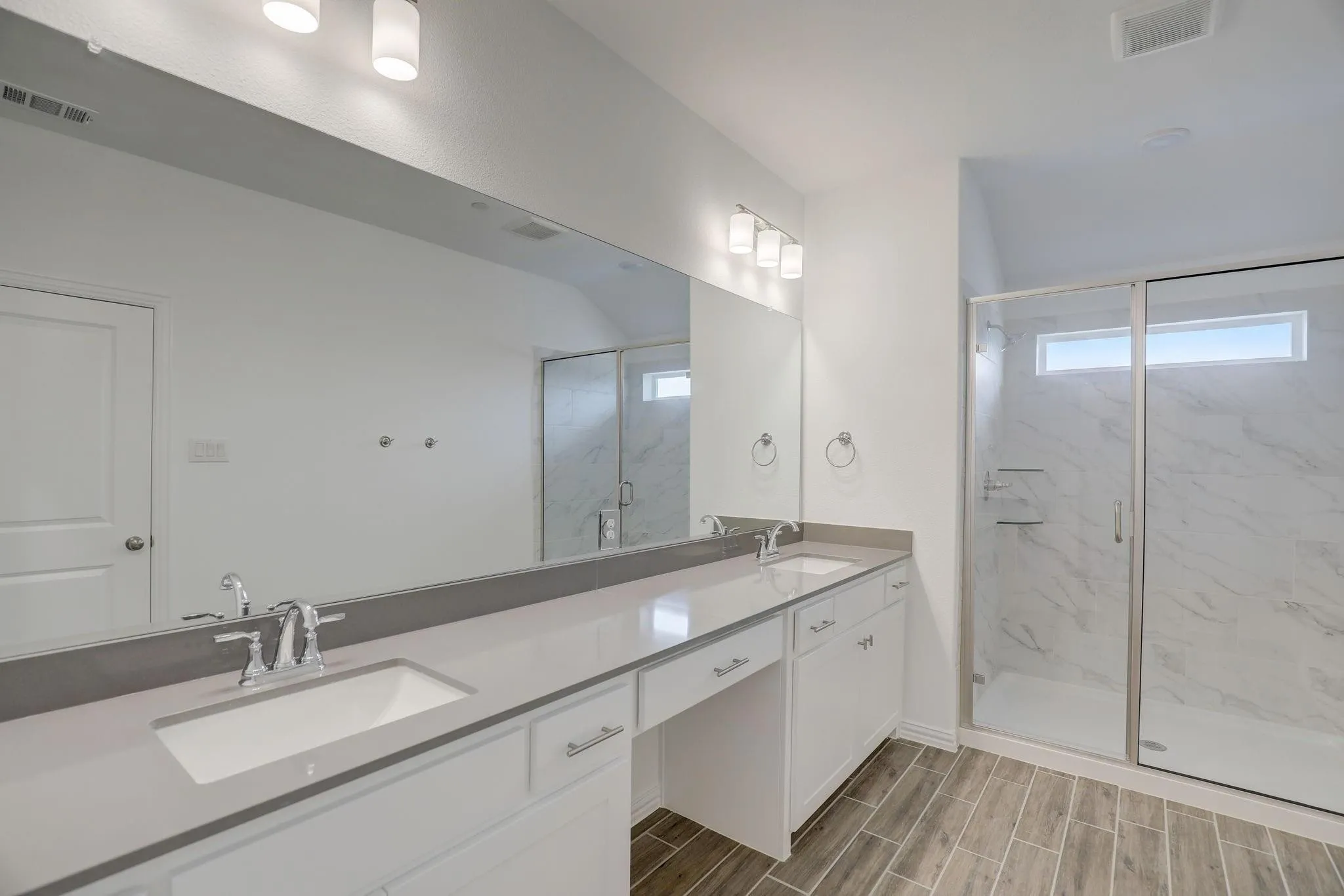 Dual vanity with white cabinetry and light-toned countertops