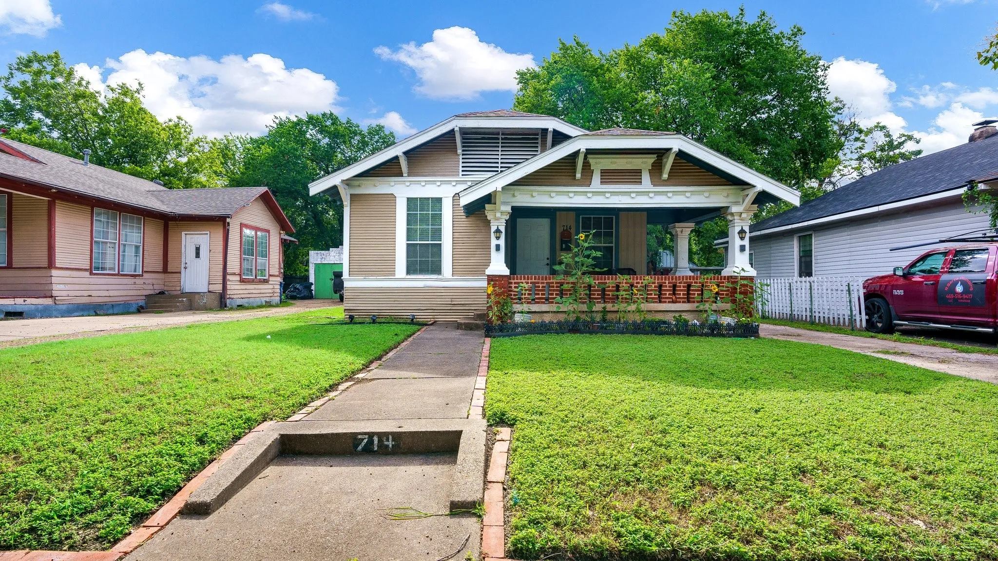 Craftsman-style facade with a covered porch, brick detailing, and white columns