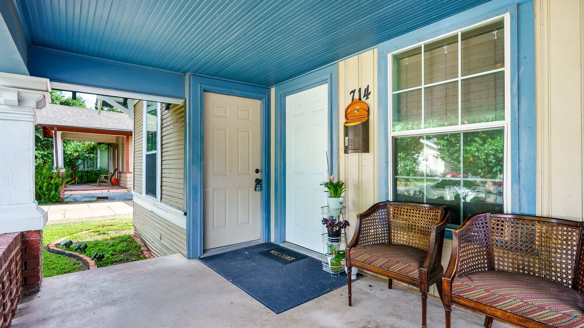 Covered front porch with blue beadboard ceiling