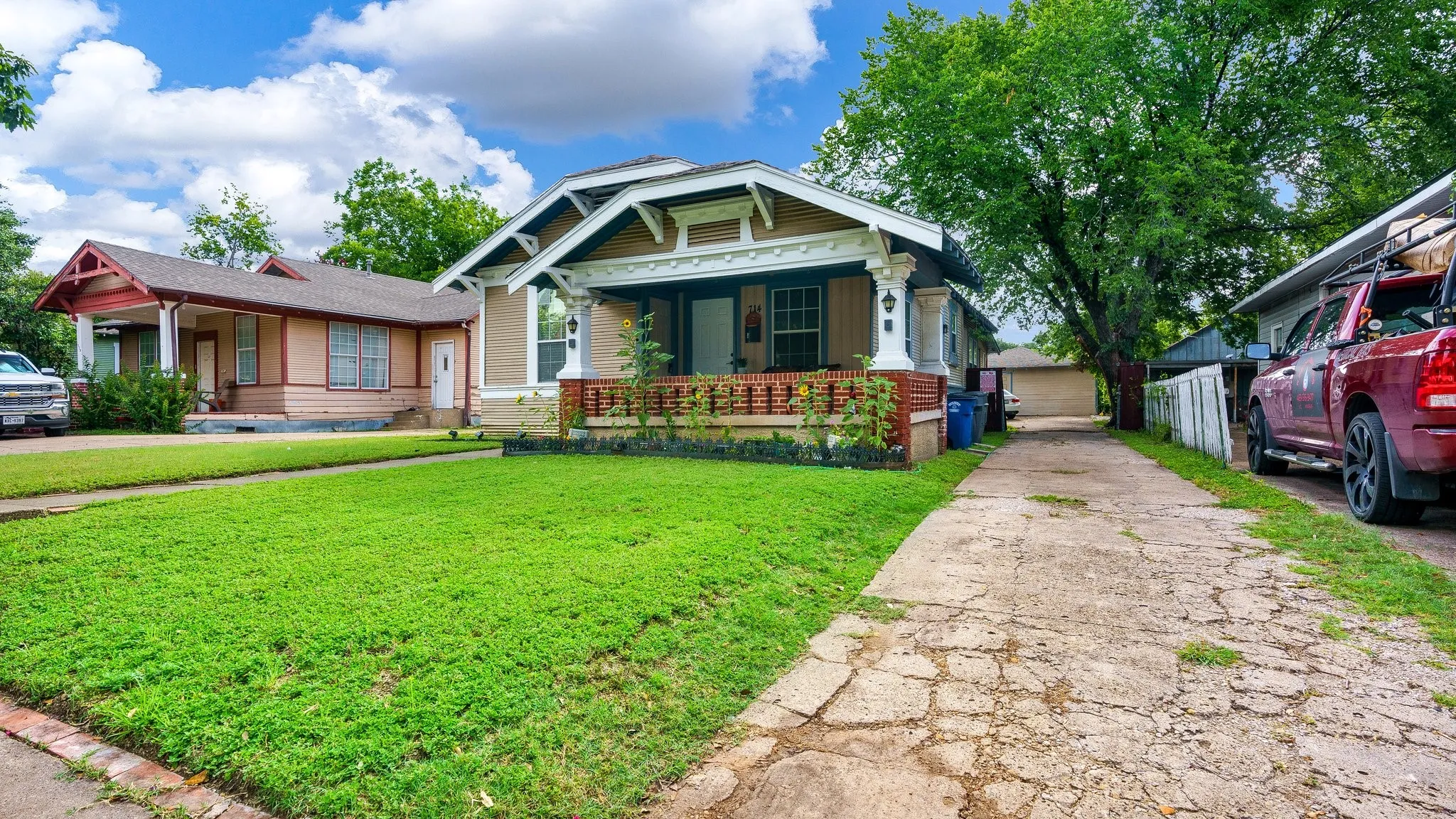 Craftsman-style home with a covered front porch, decorative porch columns, and a landscaped front yard